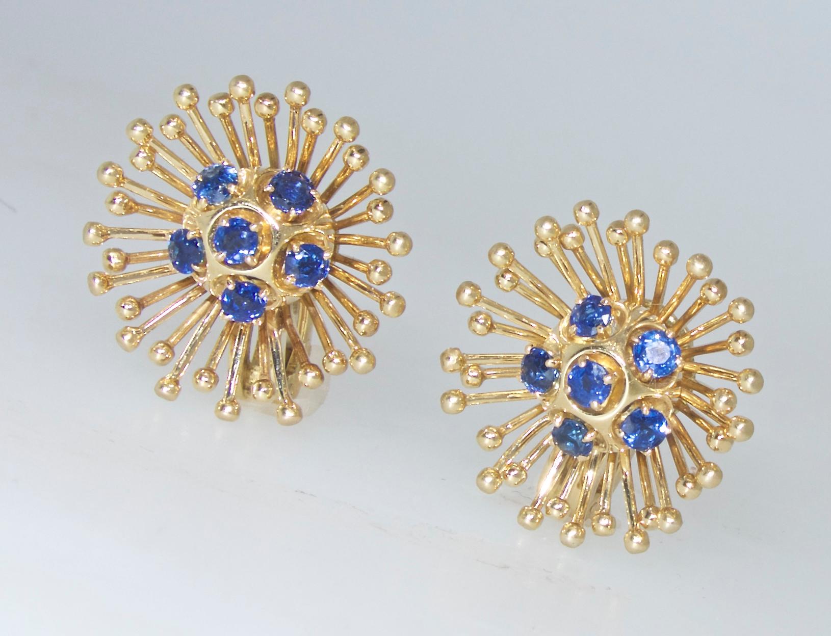 Cartier earrings centered with  12 round bright natural sapphires weighing approximately 1.20 cts.  These  18K yellow gold earrings measure just over .75 inches.  They are in fine condition and are now for a non pierced ear but can be converted by