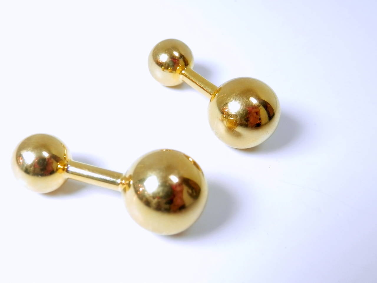 14K yellow gold uneven barbells by Cartier, c. 1949