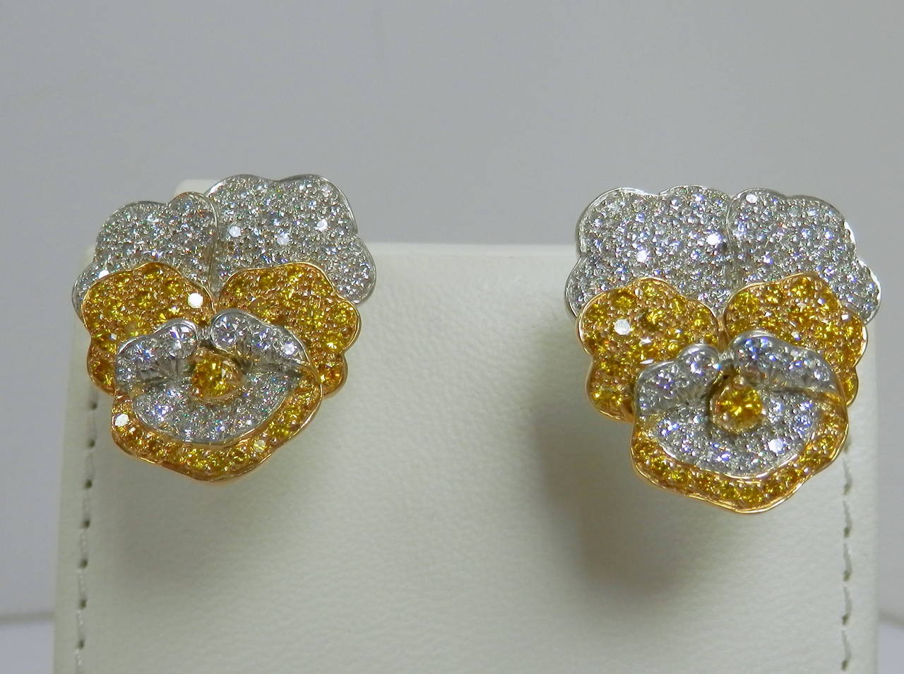 Platinum and 18K yellow gold "Pansy" motif earrings with approx. 1.93 cts of Intense to vivid yellow diamonds and 2.28 cts of white (F) diamonds. Signed and numbered Oscar Heyman.