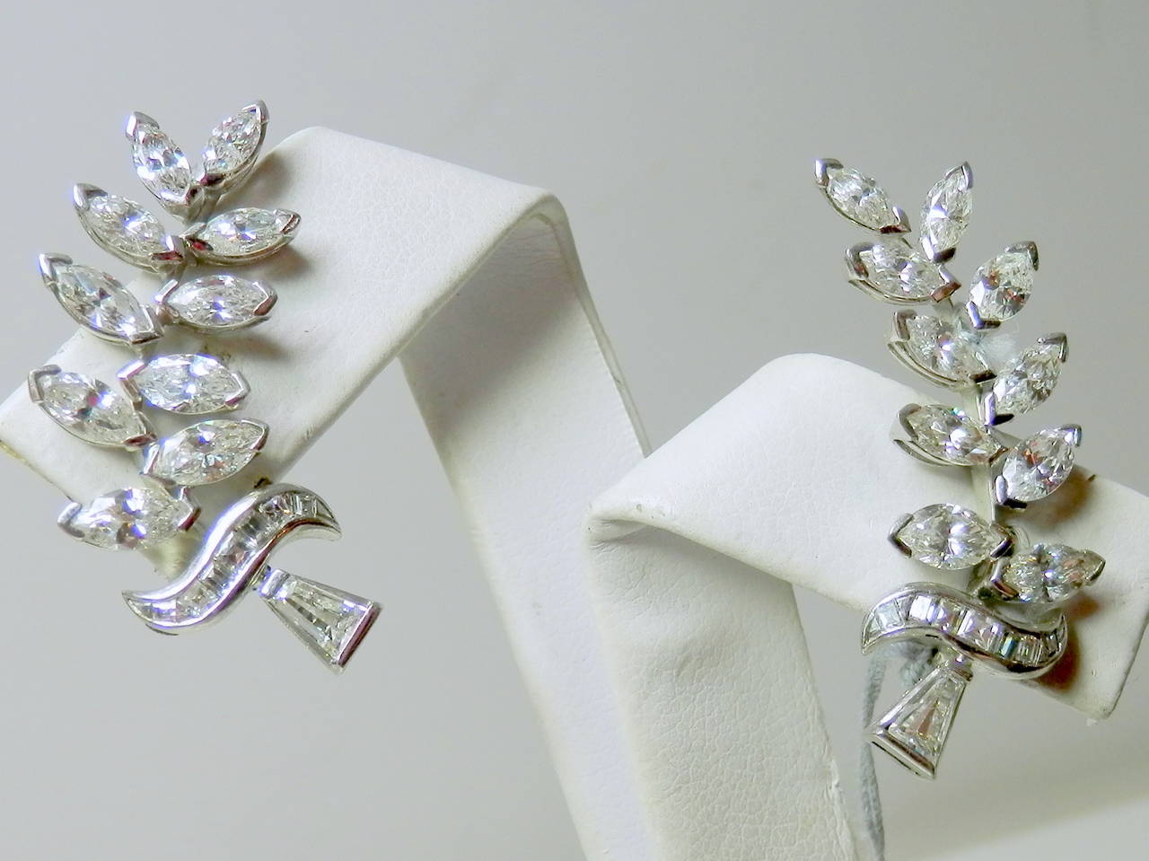 Set with marquis, triangle and baguette cut diamonds, these leaf motif earrings have approximately 4 cts. of diamonds. The diamonds are H/VS and SI.