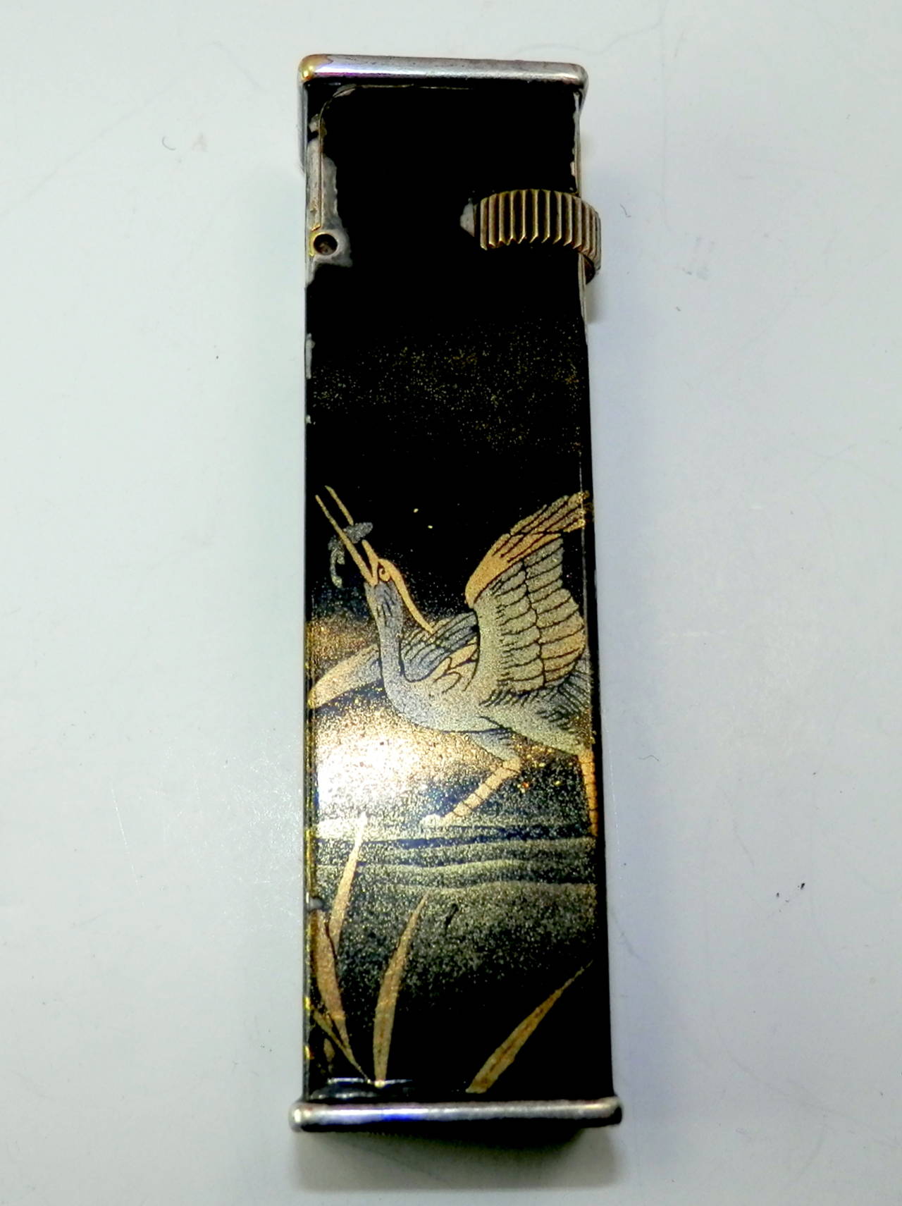 Signed underneath Cartier-License, Dunhill, fab. Suisse, with a hallmark of BL  Lacquer.  Works but needs lighter fluid.  Mid 20th century.  Beautiful motif of a bird catching fish which continues to the back.  Asian writing symbols on the lower