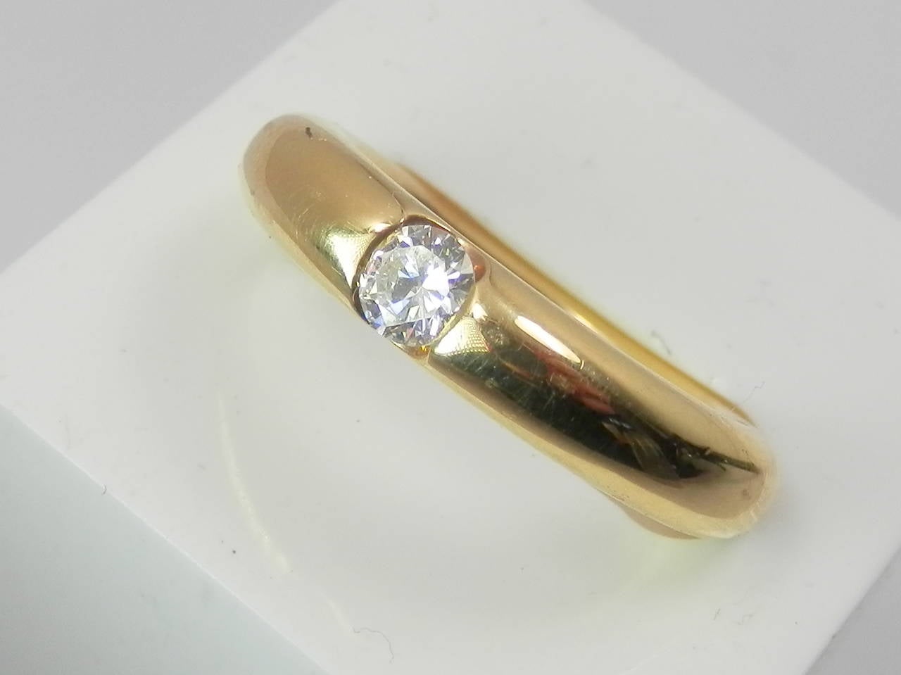 Signed Cartier, 1993,  750 52, also with French hallmarks, and 78 gr 0.25. The center diamond is .25 cts. can be sized.  Now a size 5 1/2 to 6