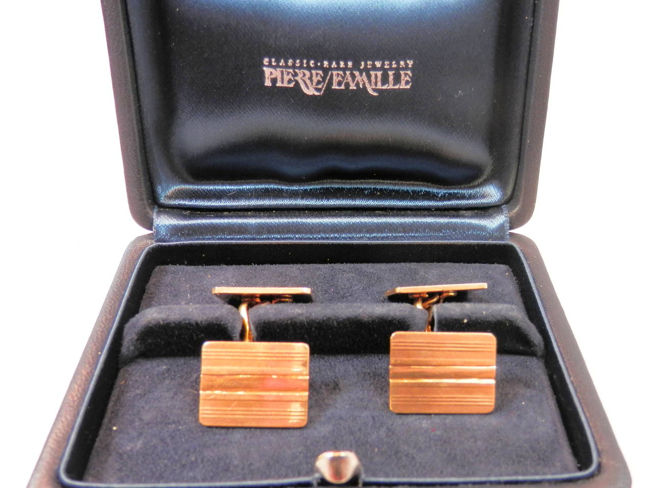 18K yellow gold rectangular back to back cufflinks  with  conservative stripes There is a center solid element which makes it easier to put the cufflinks on. Signed in block letters: Cartier.  Circa 1935