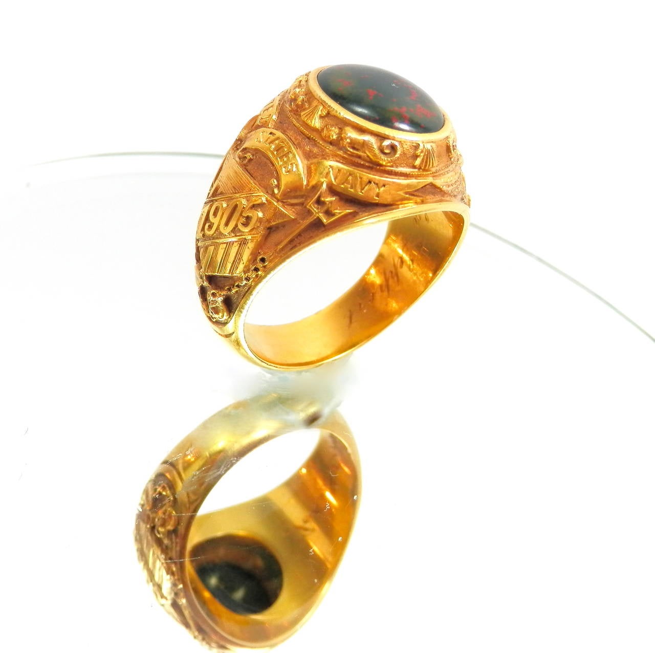 Circa 1905 U.S. Navy ring with high relief carving in 14K and with an acid finish (appears 18K)  The ring centers an oval cabochon bloodstone and with an engraving inside.  In near pristine condition where is a complex design containing 4 mermaids,