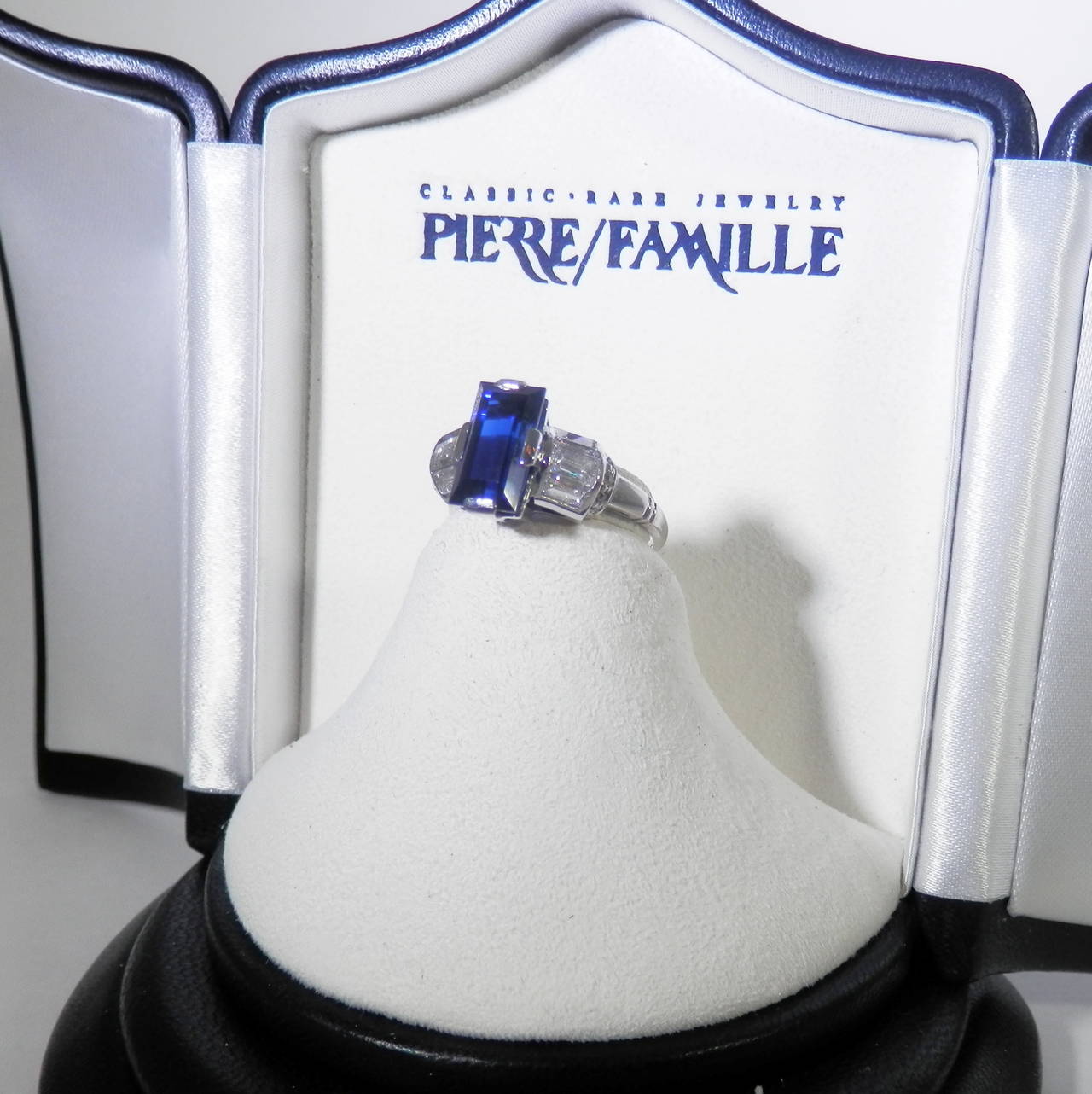 Central fancy cut natural sapphire is accompanied by a AGL Report stating classic Burma no heat sapphire.  The sapphire weighs exactly 2.87 cts.  It is accented on either side with .90 cts of baguette cut diamonds and also round brilliant cut