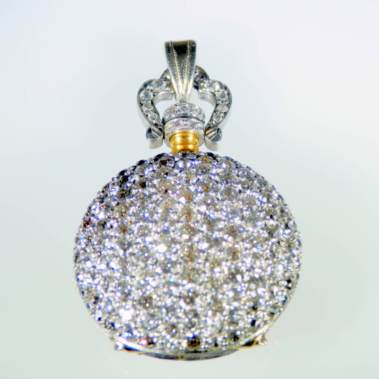 Lady's pave diamond platinum and gold pendant watch, c. 1915.  This is an exquisite all diamond pendant watch with rose cut and European cut diamonds all on a delicate chain.  It has recently been cleaned and oiled and keeps good time.  It has