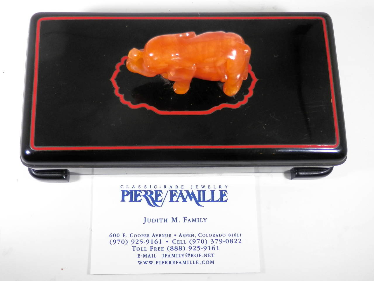 In the Persian Art Deco taste, this is a wood lined sterling silver box, measuring 6 1/4 by 3 5/16 by 1 3/8 inches.  An African elephant (finely carved in carnelian agate)  measuring 2 1/8 long by 3/4 inches wide and 1 1/4 inches high sits in a