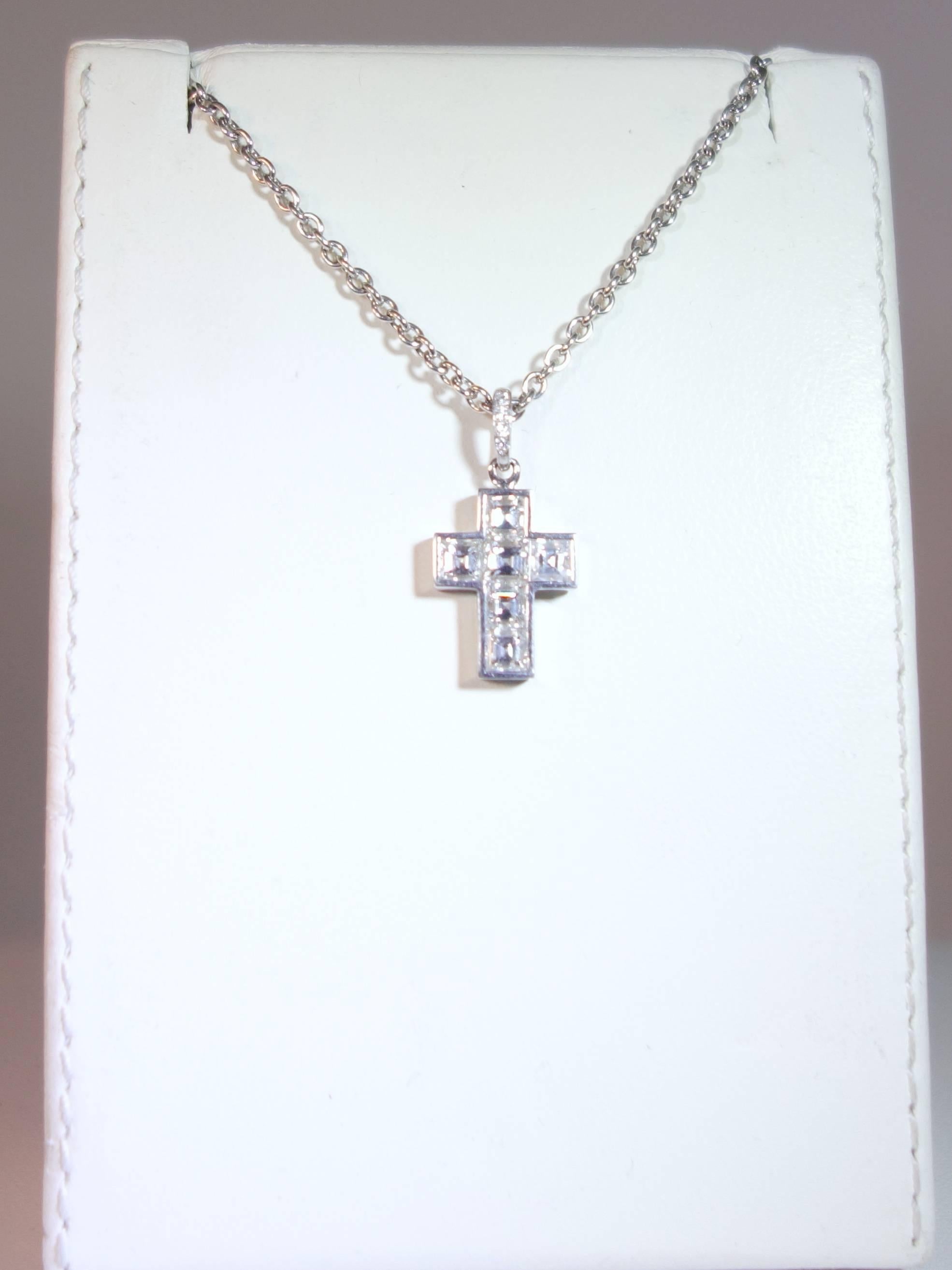 Six square cut fine diamonds all well matched and approx. (F) colorless and (VVS) very very slightly included.  Both the pendant and the chain are signed Cartier and numbered 868034.  