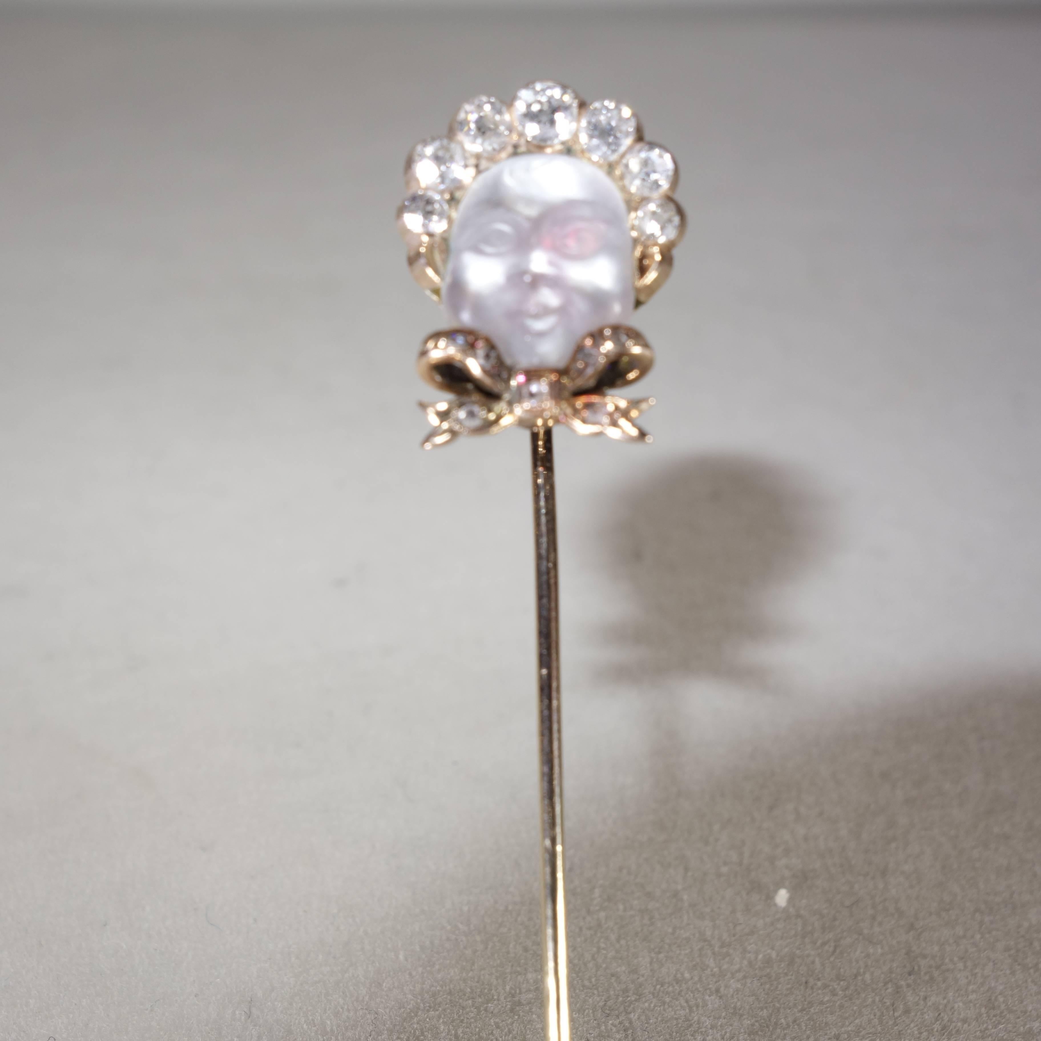 Uncommon collector's antique stick pin.  Detail carving in Burmese moonstone of a baby with a diamond bonnet with 7 graduated mine cut diamonds and 7 rose cut diamonds, 15.3 high by 12.2 mm wide.  The stick pin is 65 mm long (2.56 inches).