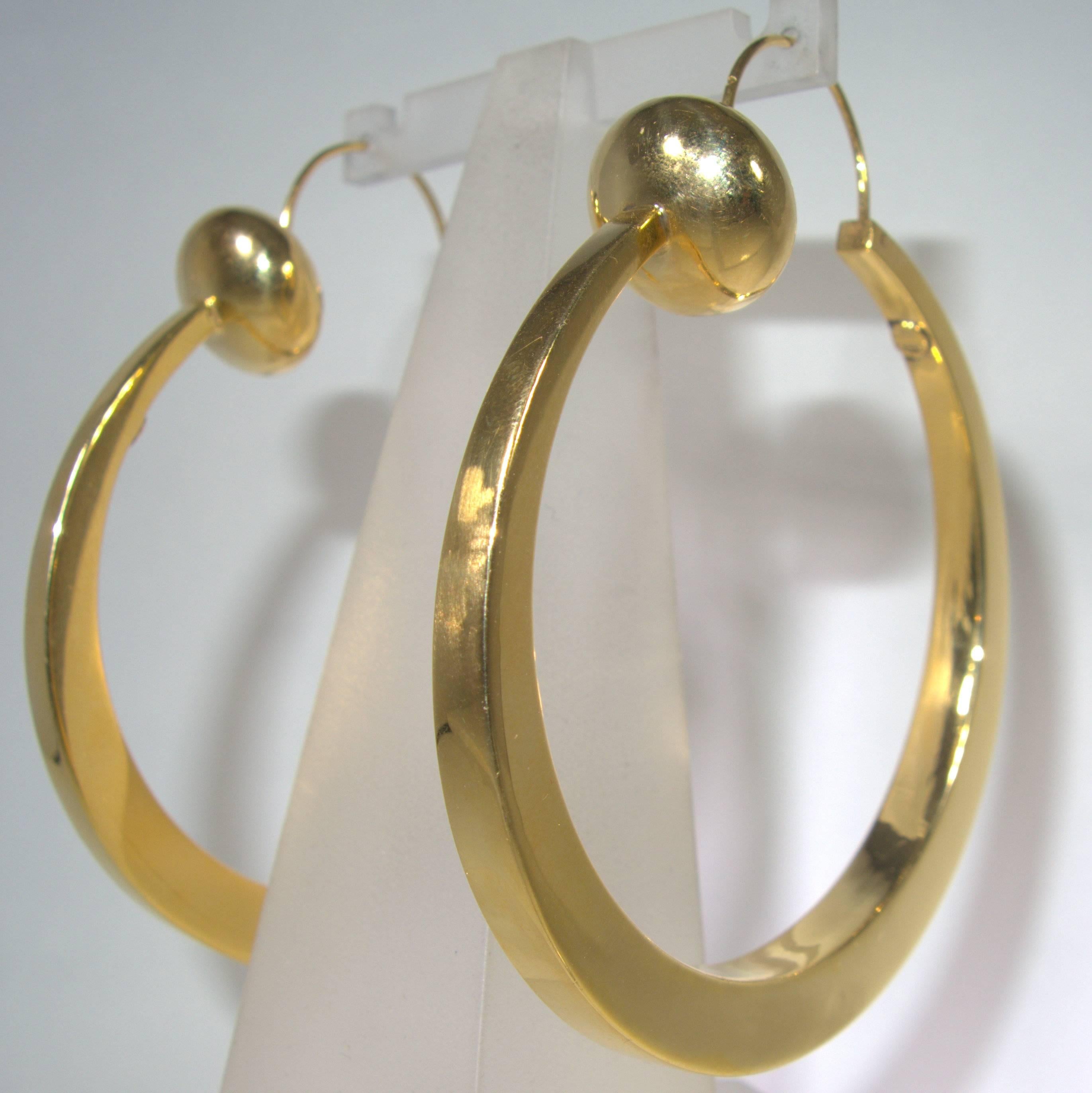 3 inches in length (2 1/2 inches in diameter) from the wire to the base, these gold hoops make quite a statement.  They are 14K and while visibly large however very comfortable to wear.  They feed through the back of the ear to the front clasping