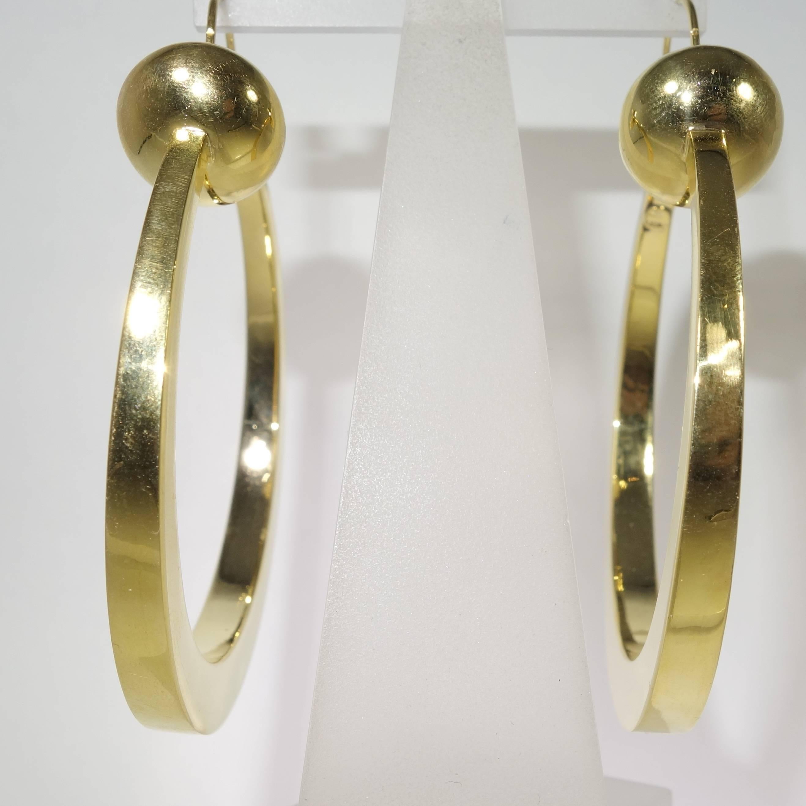 Modernist Large stylized gold hoop earrings, c. 1950.