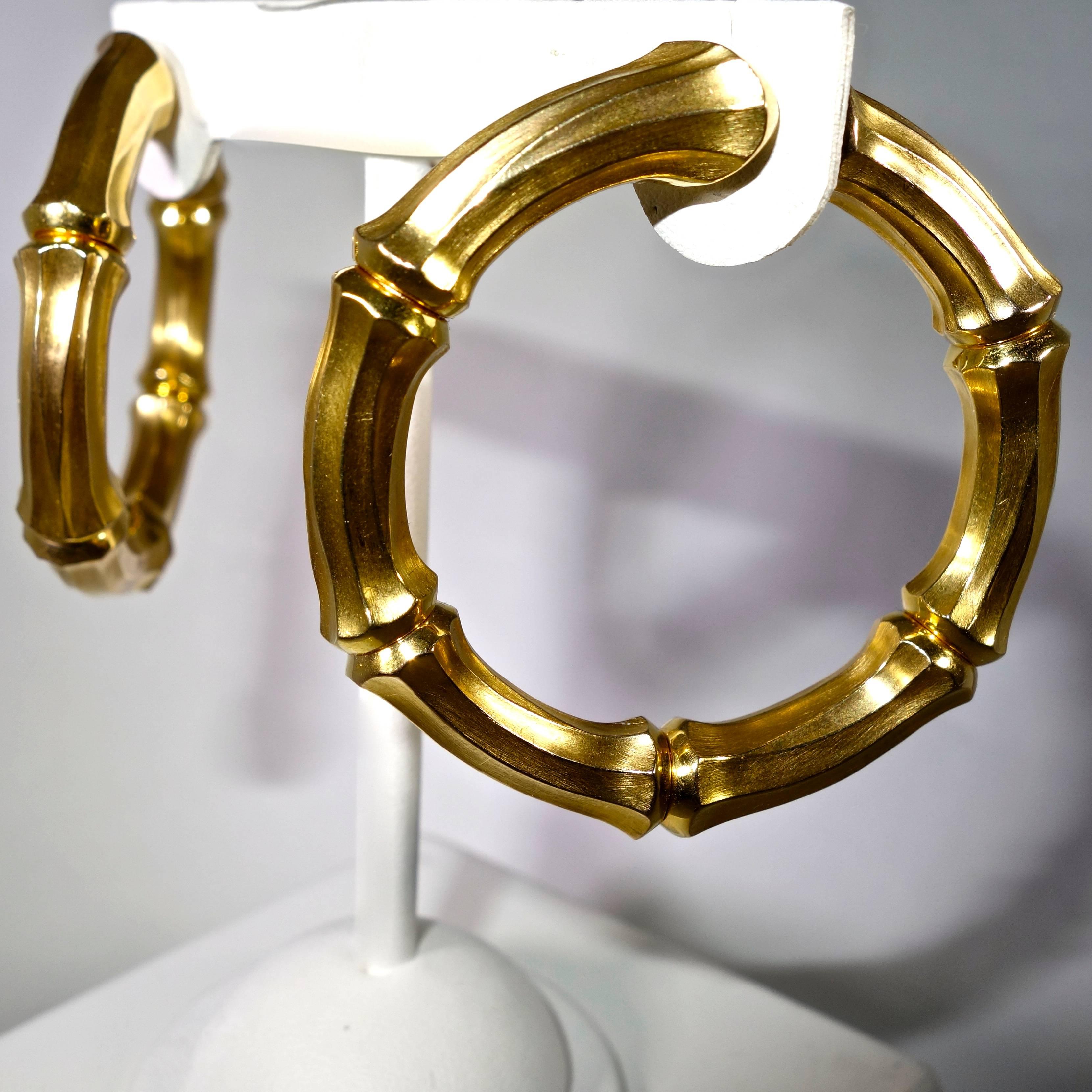 18k yellow gold large hoop earrings.  From the Cartier bamboo motif line, these earrings.  Two inches in diameter.  These striking earrings are signed Cartier, 750 (for 18K) and these pieces are numbered 651893. Theses earrings are accompanied by