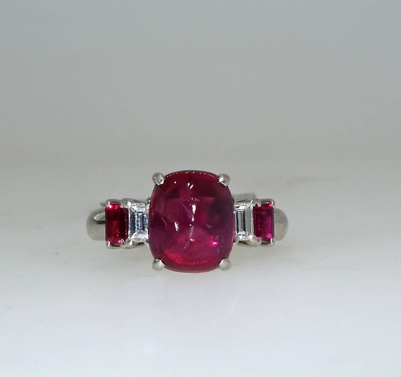 Prong set in platinum, centering this hand made ring is a fine natural unheated Burma ruby which is accompanied with a certificate from GIA  stating that the stone is unheated and Burma.  This ruby weighs 4.08 cts.  It is accented with fancy white