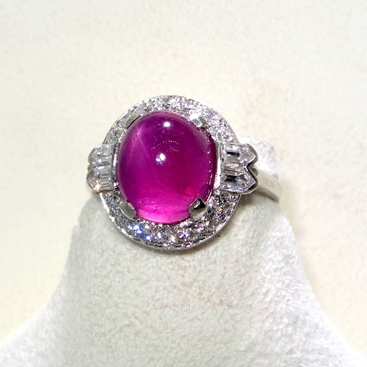 The central oval stone, weighing exactly 6.51 cts., is a fine natural unheated star ruby accented by fancy cut diamonds.  The diamonds are all well cut and are near colorless (H), approximately and slightly included to the first degree.  The