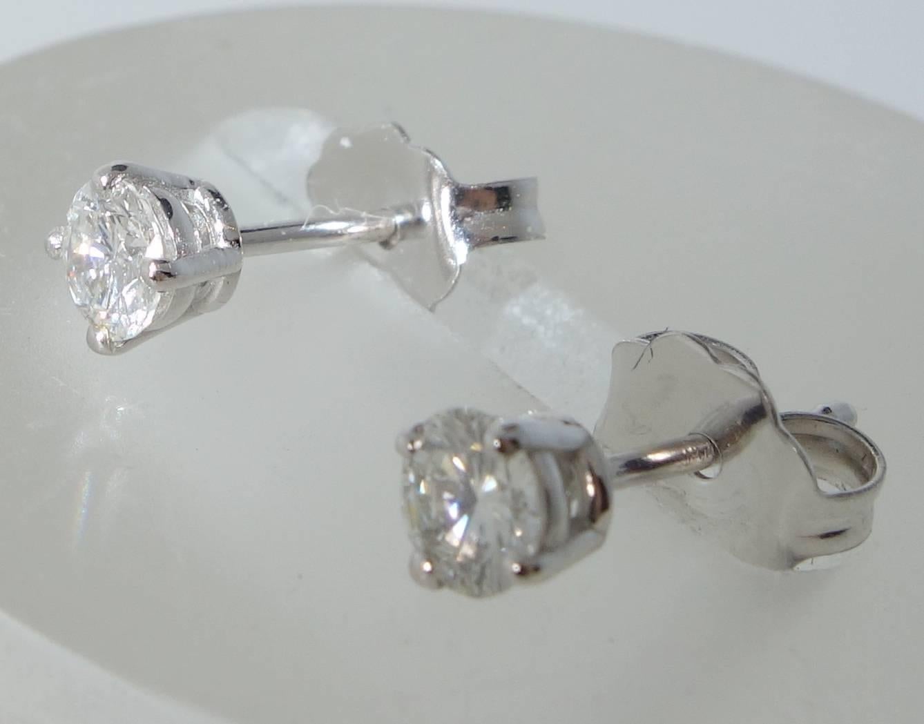 .35 pts., is the total weight of these white brilliant cut diamond studs.  The matching round diamonds are approximately F/G (colorless to high end of the near colorless range), and VS1 (very slightly included to the first degree).  The four prong