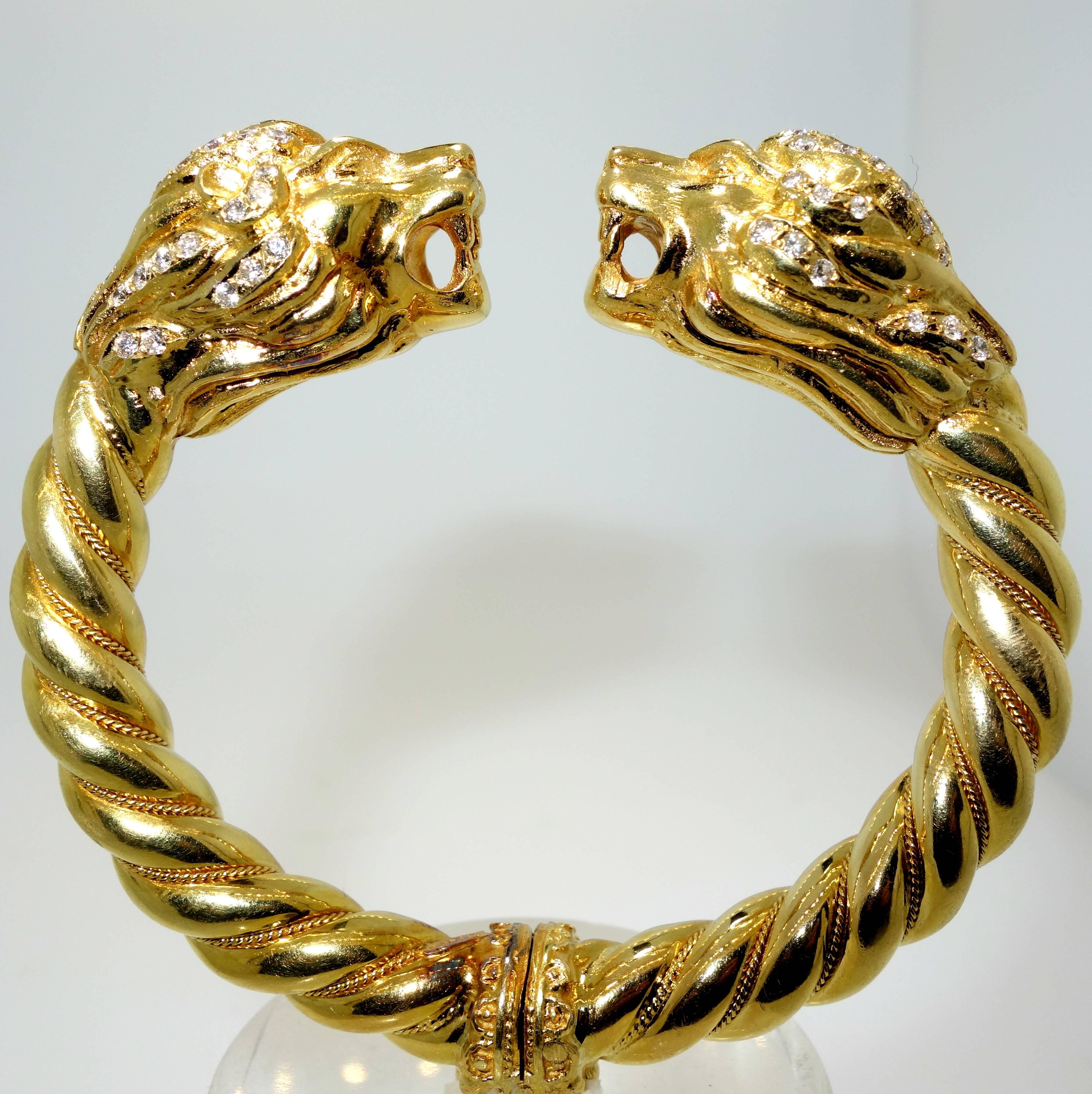 A robust 3.01 troy ounce (93.8 grams) bangle bracelet of opposing lion's  heads.  Their mane is set with 84 modern brilliant cut white diamonds (H/I) near colorless, and very slightly included (VS), in clarity, approximately.  The total diamond