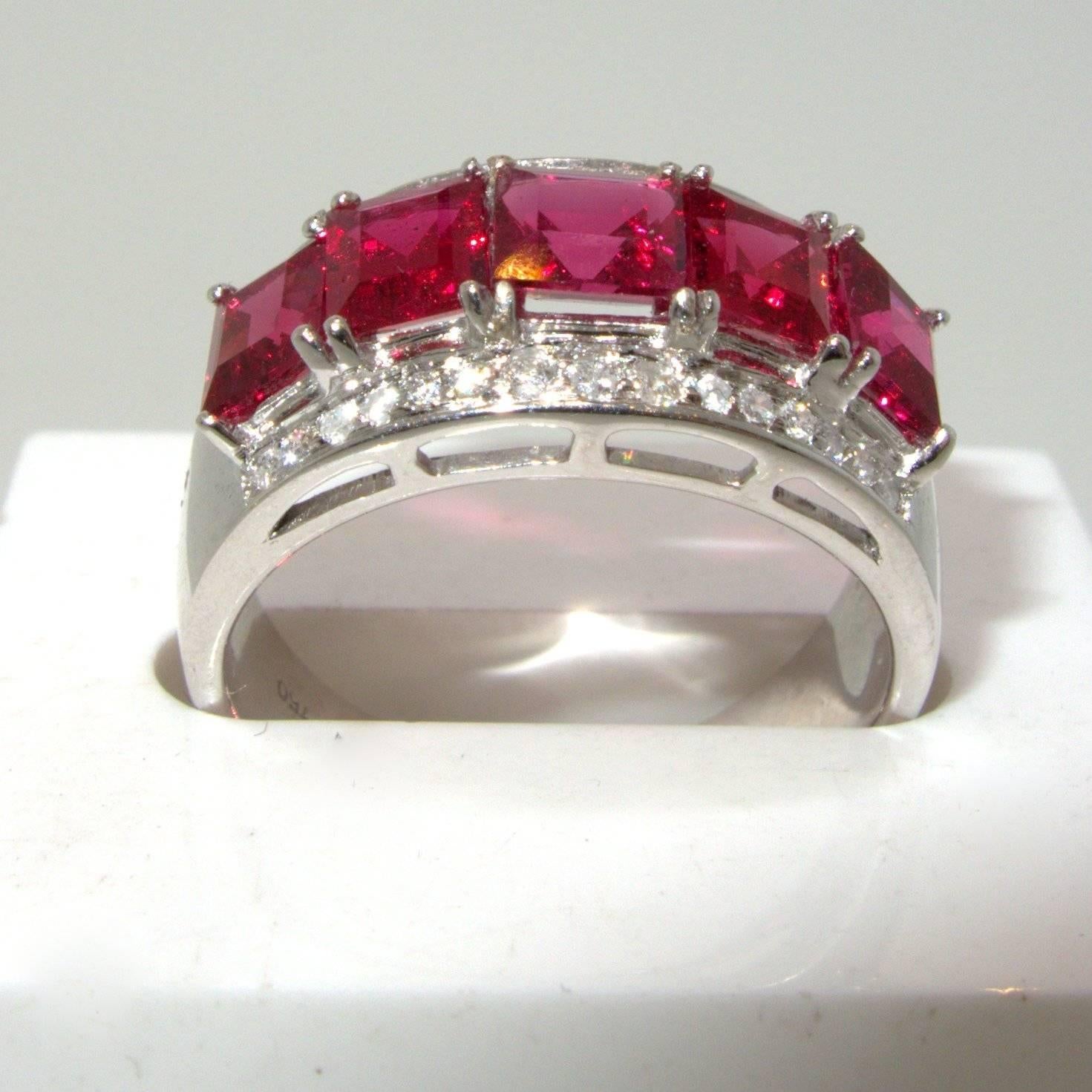 Probably from the Burma region, these 5 square cut vibrant red spinel are accented with 30 round modern brilliant cut diamonds.  The total weight of the spinels is approximately 4.50 cts.  These stones are well matched, clean and bright.  There are
