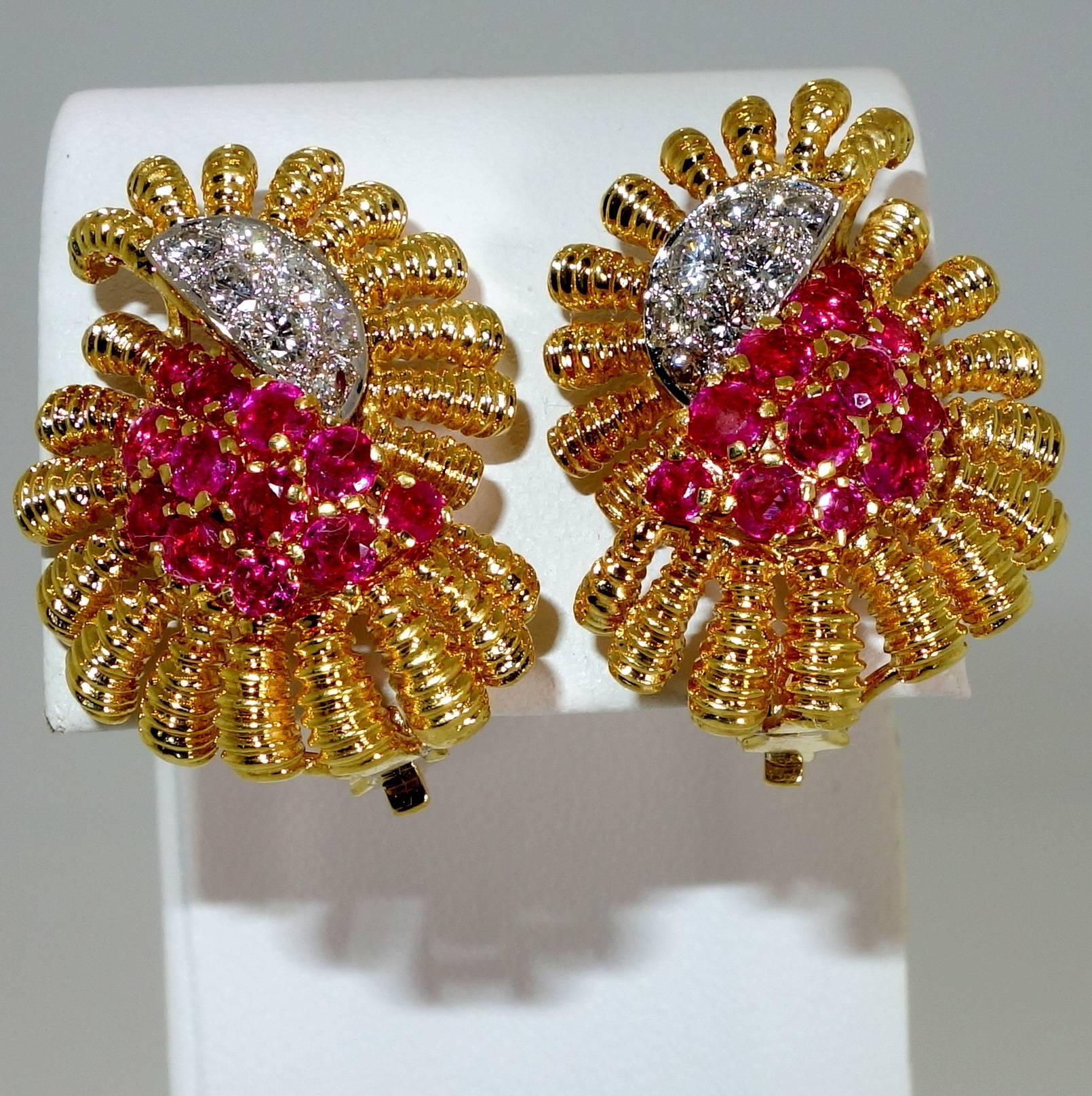Done in an unusual double sphere motif centering 1.50 cts. of Burma rubies and .75 cts of diamonds, these clip on the ear earrings can be worn either for a pierced ear or non pierced.  The diamonds are bead set in platinum. These earrings are about