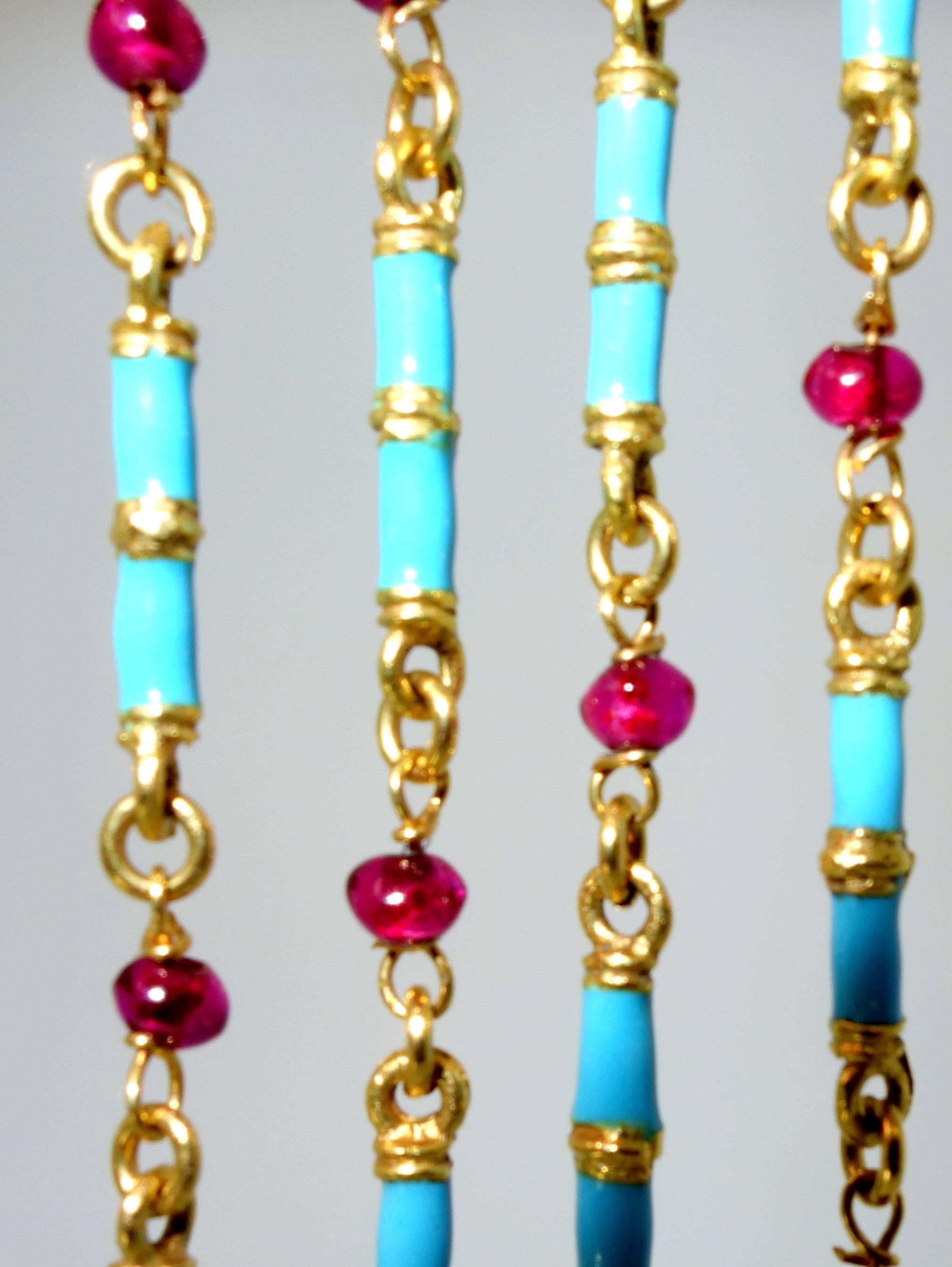 32 inches in length with 29 turquoise blue batons interspersed with 32 Burma ruby beads, this heavy well made 18K gold chain can be worn double or as a single long chain.  With approximately 5 cts., of rubies, this chain is a nice color combination