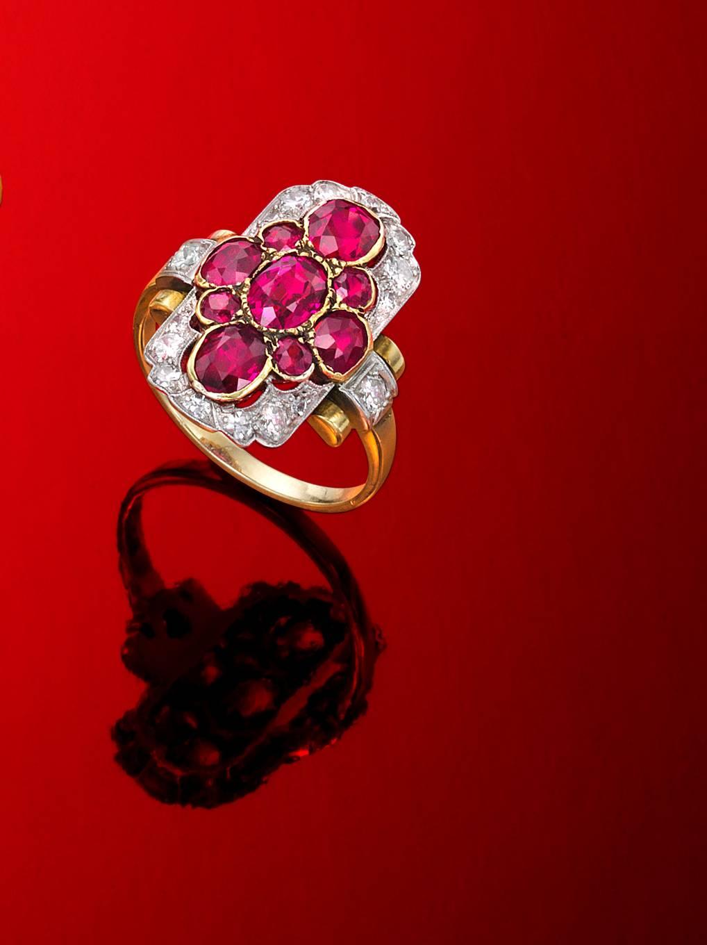 Wonderful natural unheated Burma rubies and surrounded by old cut diamonds.  This Belle Epoque ring is platinum on gold.  There are 9 fine rubies amounting to approximately 2.25 cts., and 16 diamonds amounting to approximately .50 cts.  This ring is