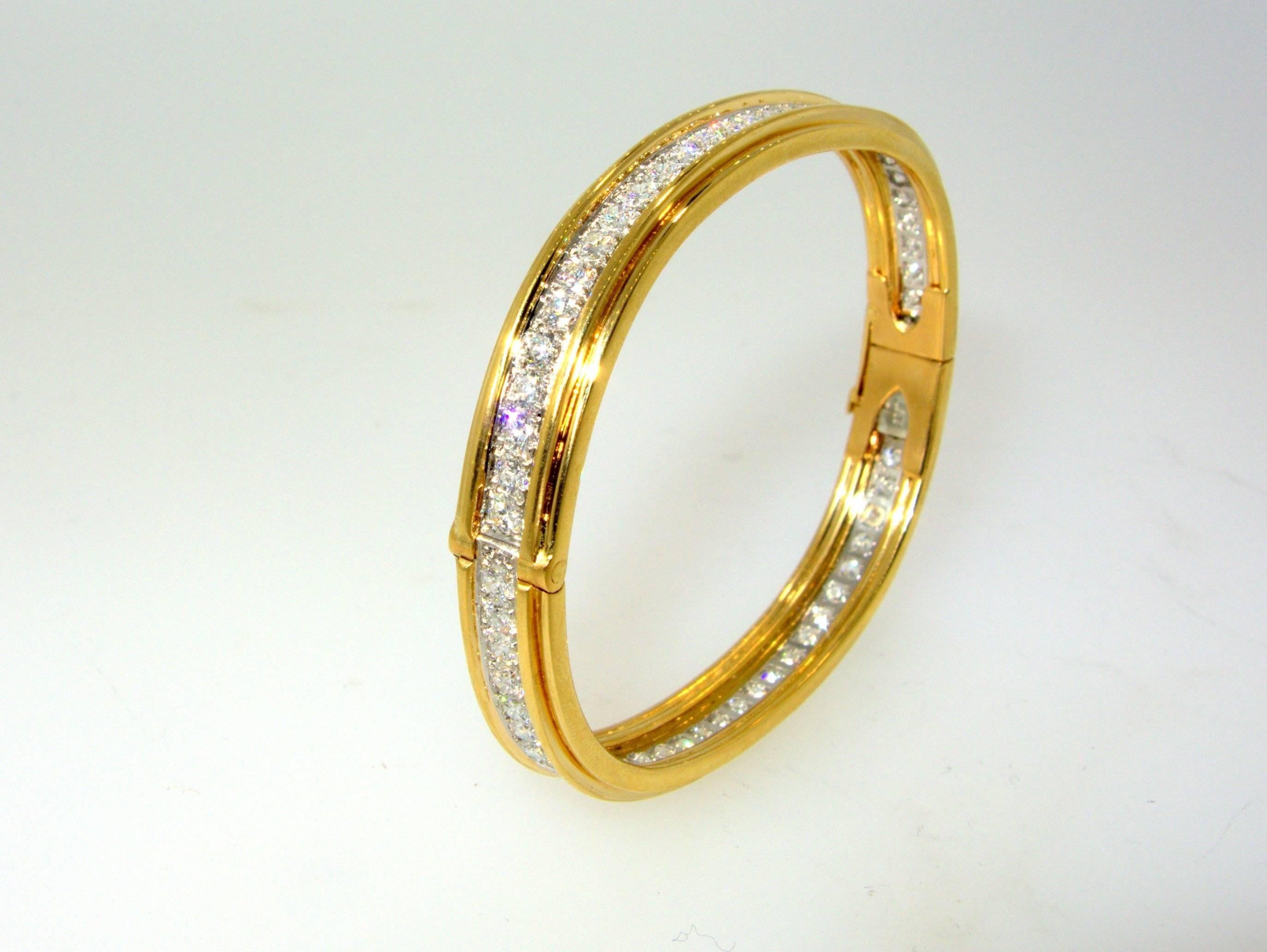 18K and platinum, this bangle bracelet possesses very fine diamonds set into platinum and rimmed with gold.  The 62 diamonds are all colorless (F) and very very slightly included (VVS).  There are approximately 5 cts.  This piece is a good size, it