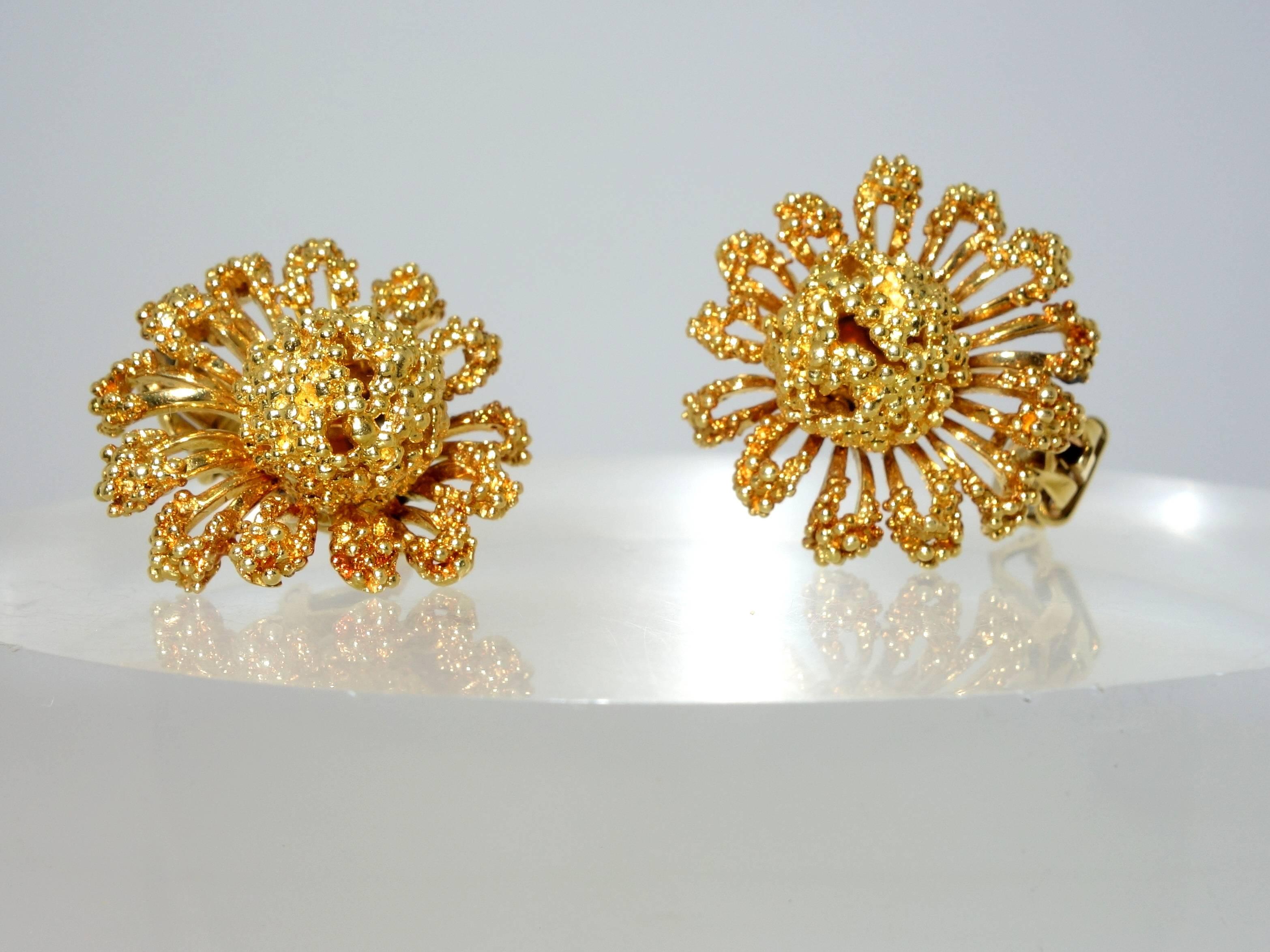 Abstract flowers in bright 18K yellow gold weigh 26.26 grams (about 85% of 1 troy ounce), and spread one inch on the ear.  These date to the early 1960's when jewels were supposed to be both feminine and supremely sophisticated.  These earrings can