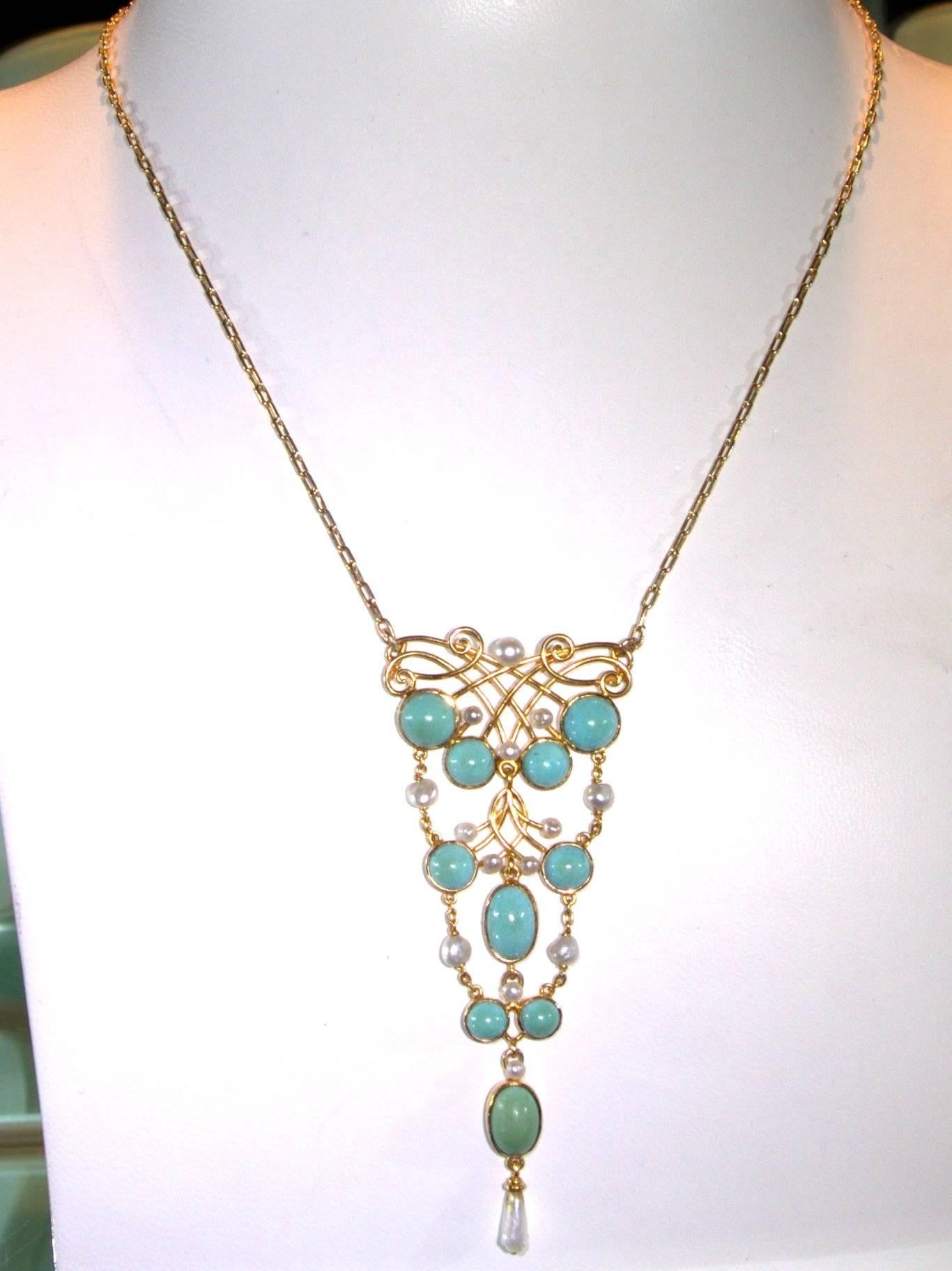  15 natural pearls and 10 turquoise decorate this long Art Nouveau necklace/pendant.  The pendant portion is 3 inches long and it is suspended from the original chain which is 17 inches long. This 14K (marked 585) is European, circa 1905.