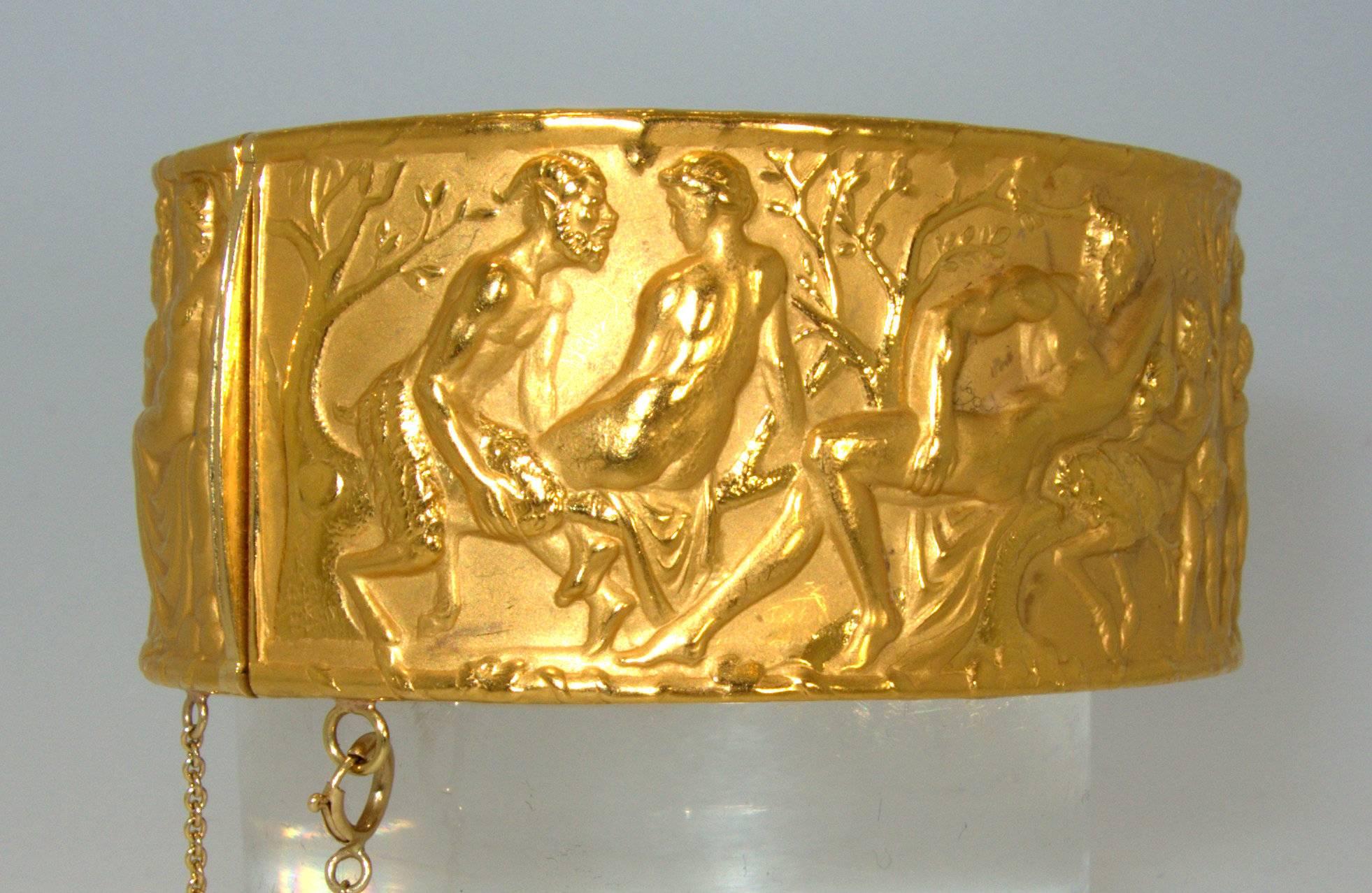  18K yellow gold with an erotic motif of different scenes inspired by A 
Midnight's Summer's Dream. This  bangle has an approximately  7 1/4 inches inside circumference and is 1.25 inches wide. It weighs 1.63 troy ounces.