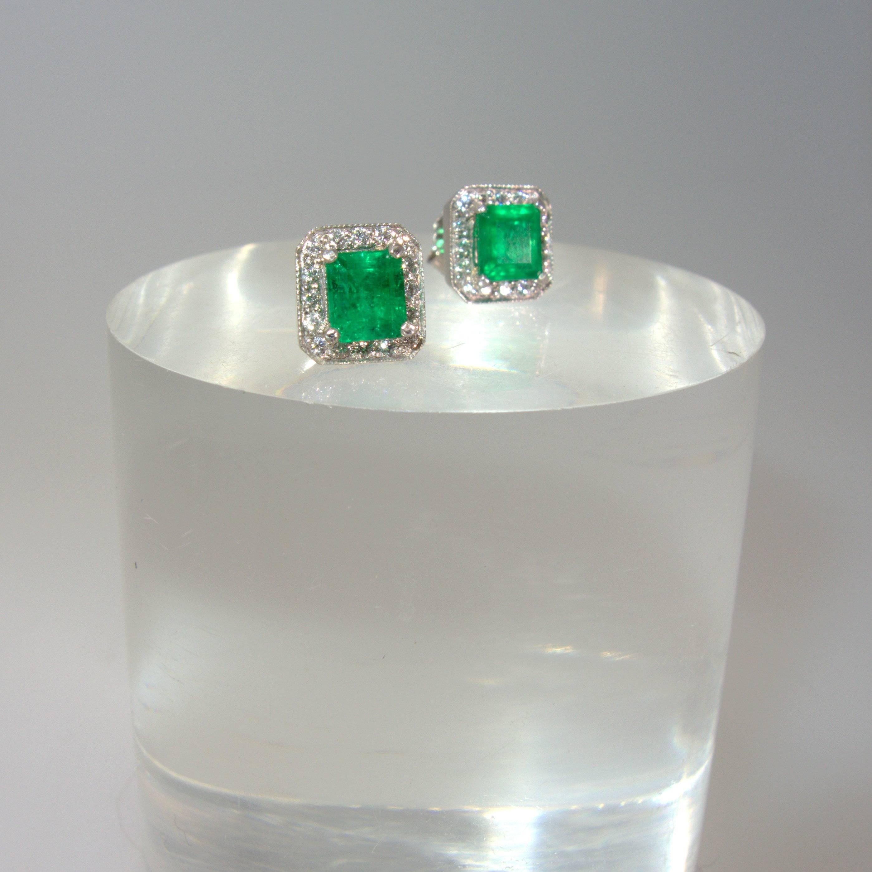 32 fine white round modern brilliant cut diamonds (one third of a carat), accent the bright green emeralds which weigh approximately 1.60 cts totally.  The earrings measure 5/16th (nearly 3.8ths) square.