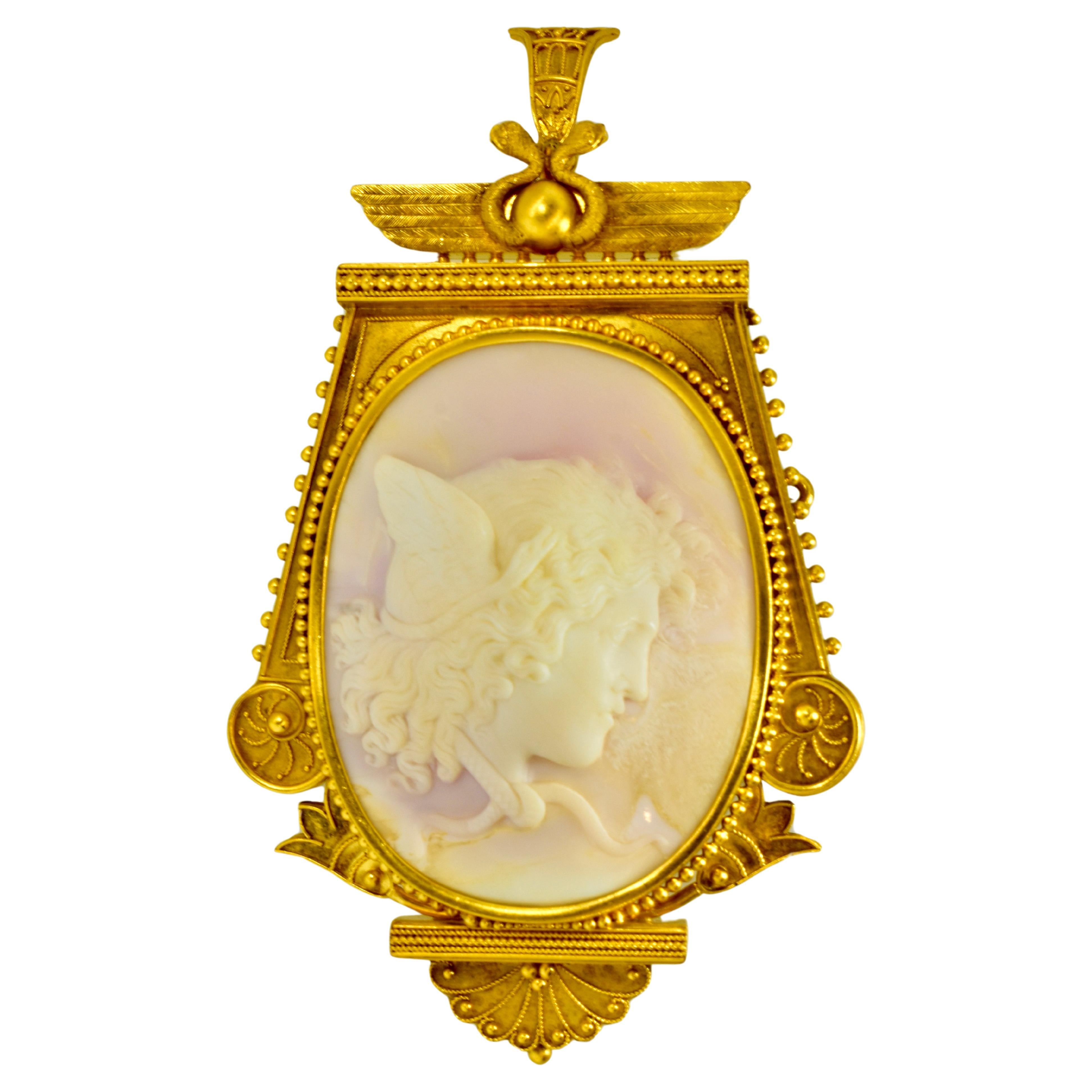 Large and Exquisite Etruscan Revival pale pink hand carved conch shell cameo of Medusa, American, 1875.

Set in 14K yellow gold with an acid finish or 