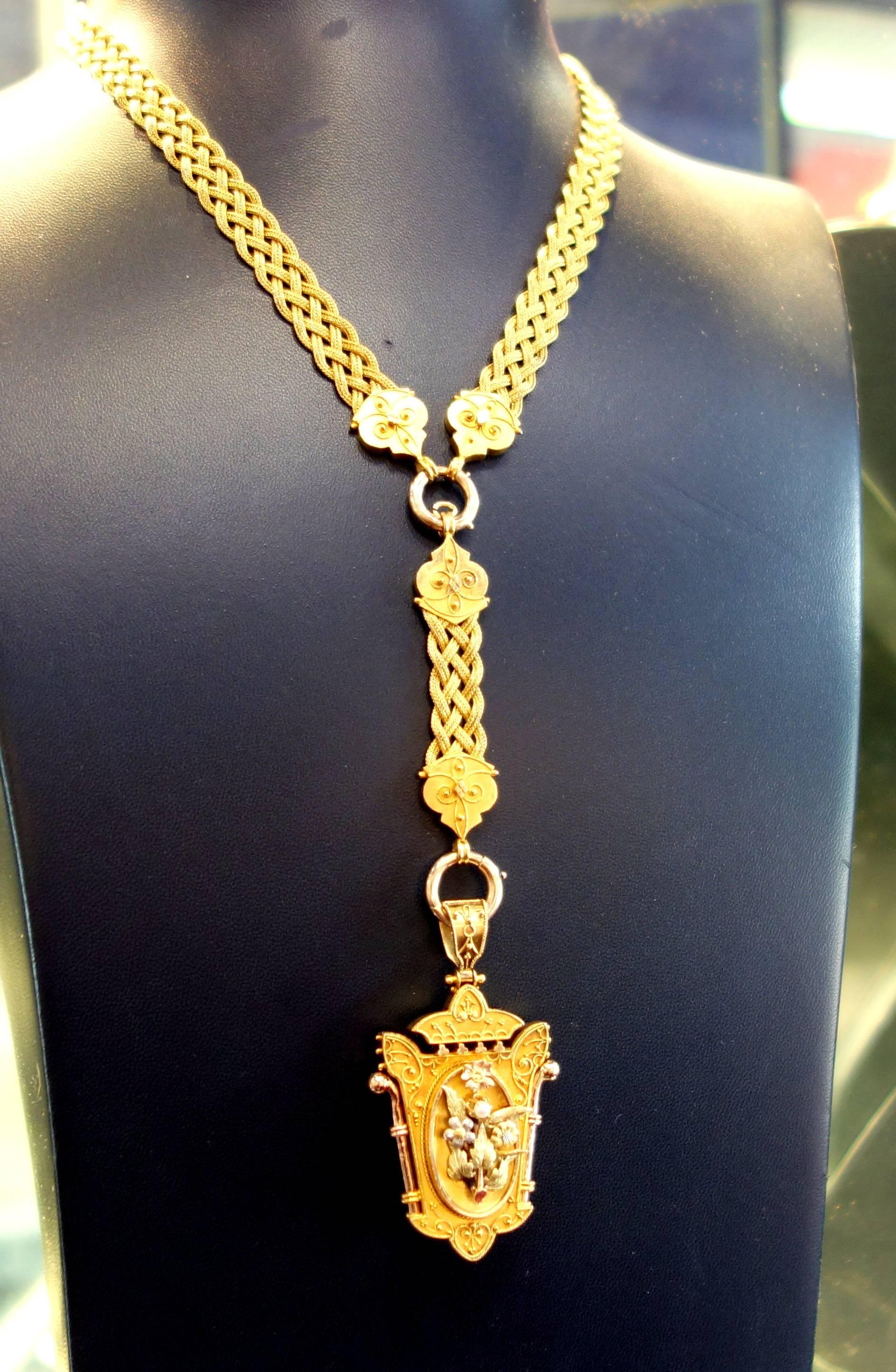 Mid 19th Century braided 14K gold necklace suspends thee original matching locket/hair receiver.  The braided necklace can be worn at its longest length of 21 inches or one can remove the pendant element and wear it shorter at about 18 inches.    