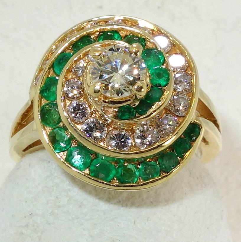 A bright and lively statement , this handmade ring weighs 7.6 grams of 18K set and possesses approximately 1.10 cts. of fine white round modern brilliant cut diamonds, with the center diamond weighing approximately .44 cts., near colorless and very