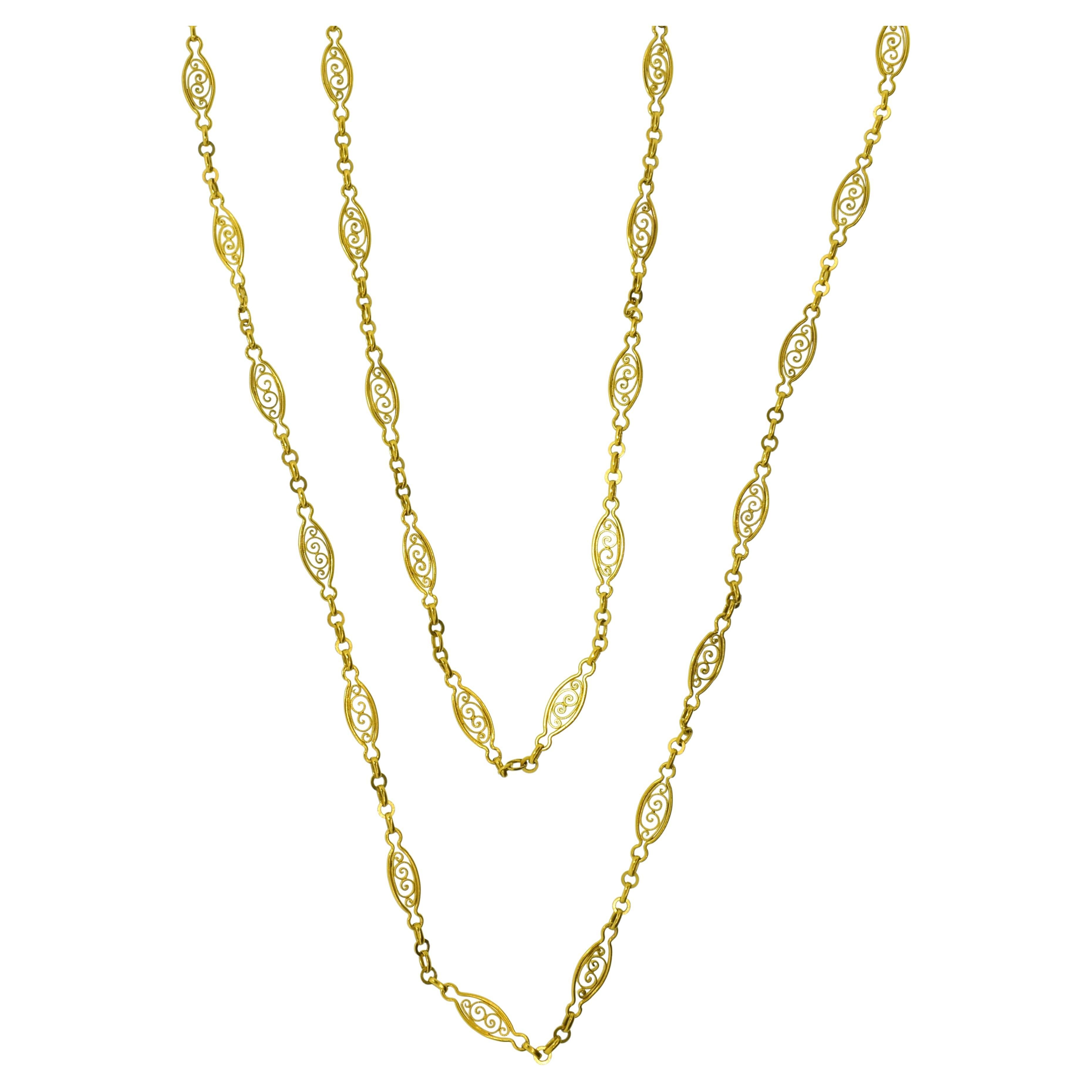 18K gold long chain, French, c. 1900.  An intricate and unusual handmade link, 59.5 inches long, 30.86 grams.  This antique French chain can be doubled over and even tripled.  An its widest, the link is 5.5 mm.  This chain looks wonderful on its