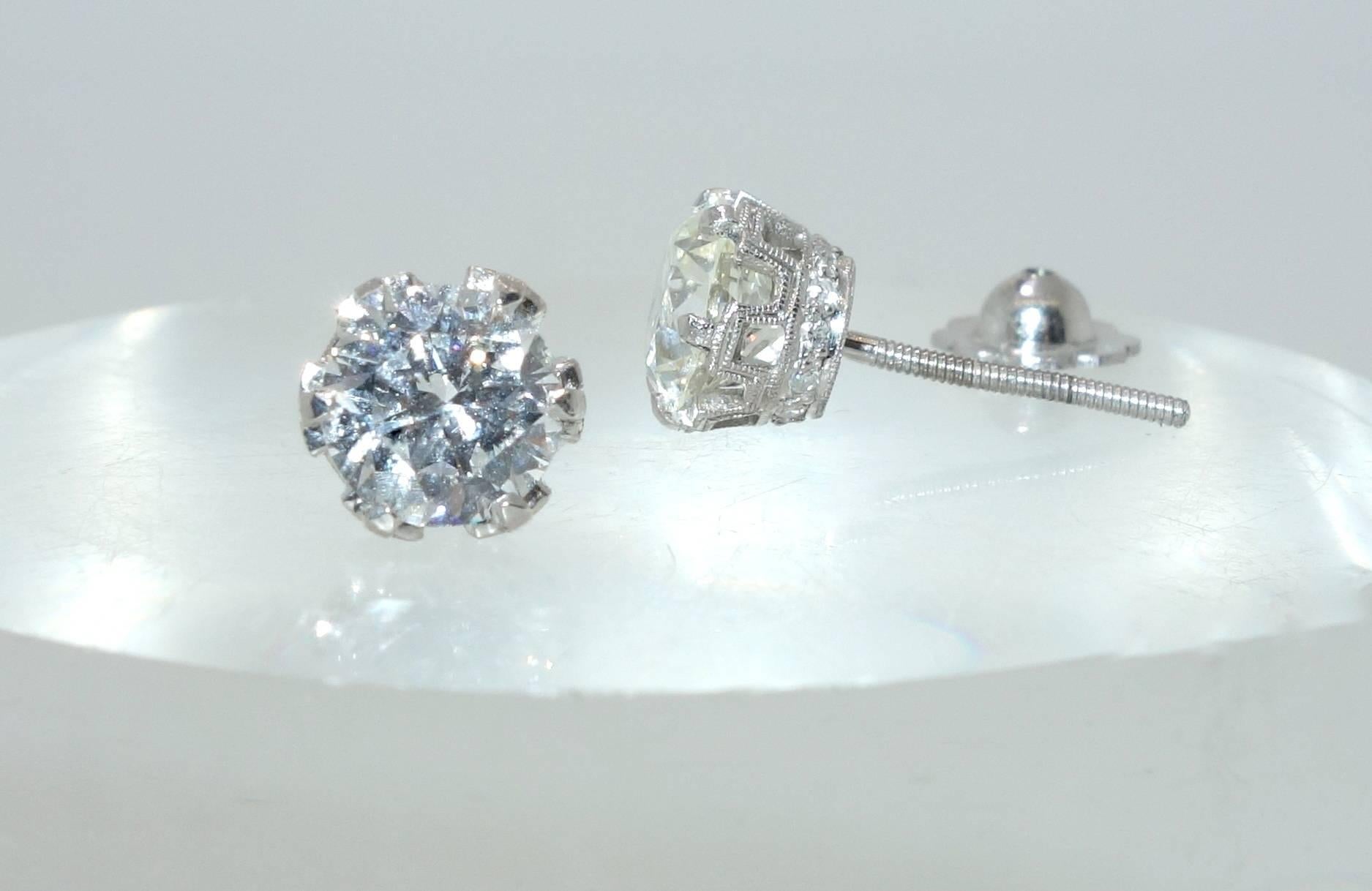 Fine platinum mountings which have small diamonds accenting the sides, possess a total weight of 2.12 cts of round brilliant cut diamonds.  The diamonds are I, VS2 and J VS1.  (near colorless and very slightly included).