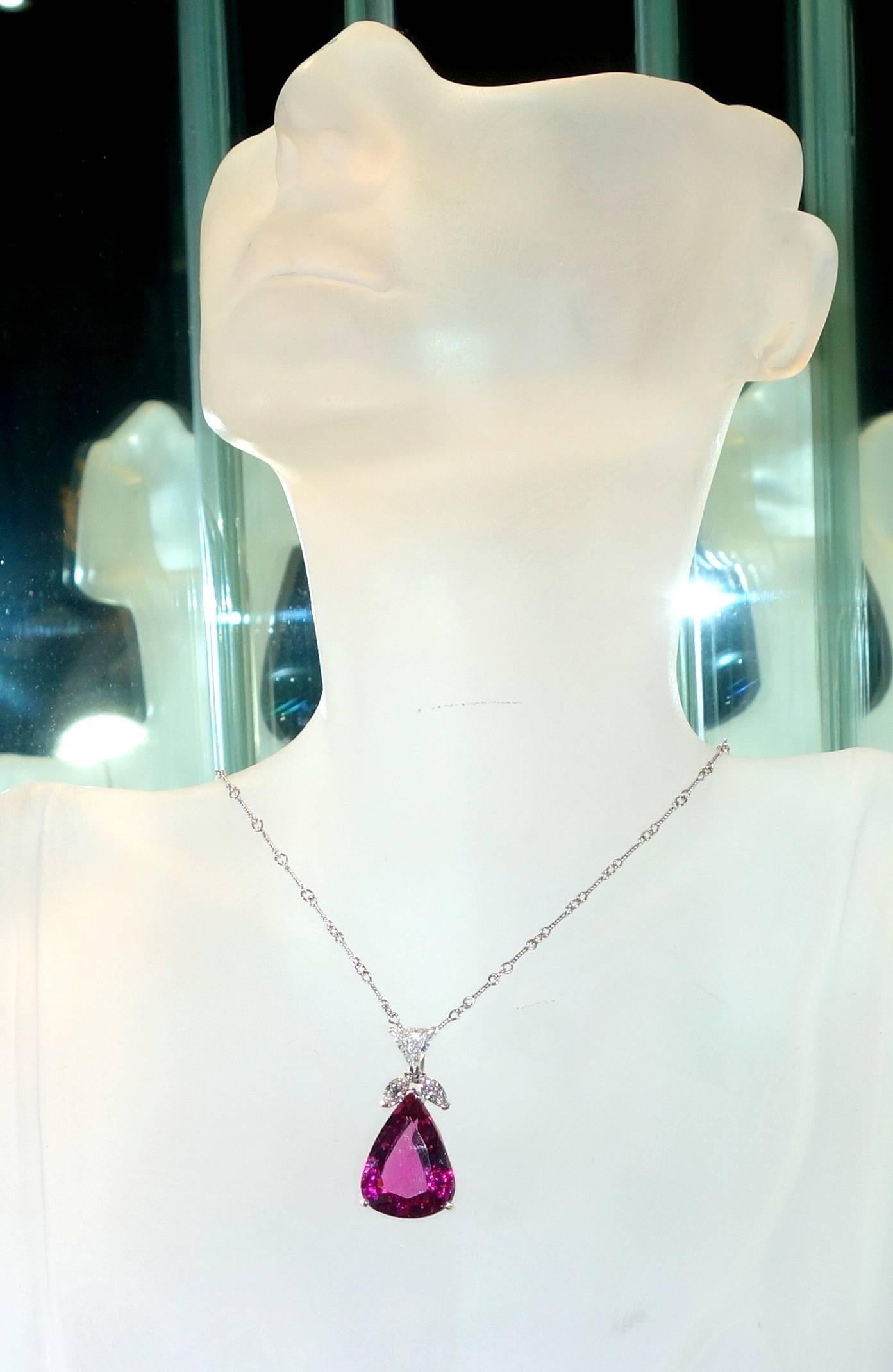 Fancy cut diamonds accent a fine pear shaped Rubelite (pink tourmaline).  The vivid pink Rubelite weighs 14.62 cts.  The fancy cut diamonds weigh just under 1 ct. (.95 cts.).  The pendant is just over 2 inches and the chain is 16 inches long.