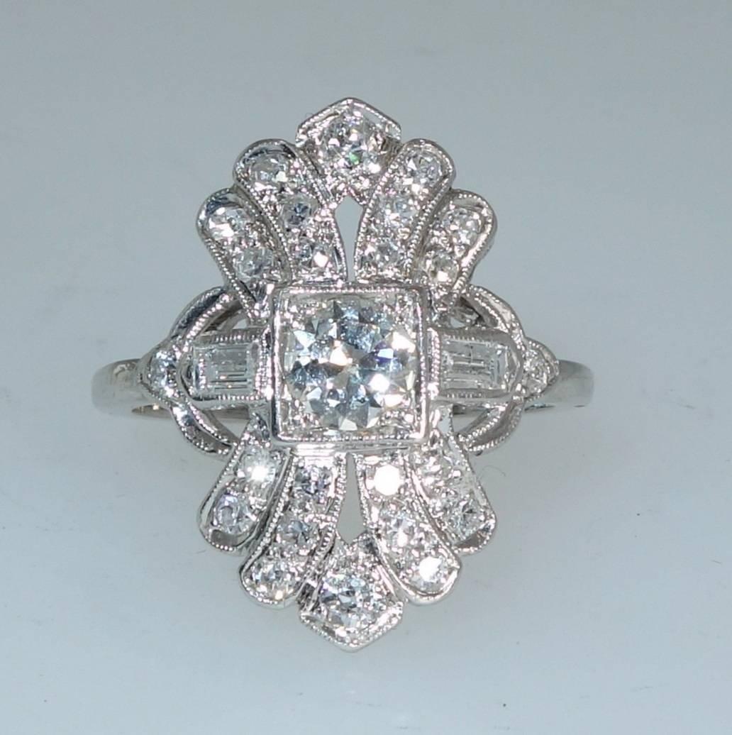 Fine early 20th century hand made platinum ring with slightly more than 1 ct. of fine European cut diamonds.  The European and baguette cut diamonds are all slightly included and near colorless (H/I).  The ring can easily be sized.  It is now a size