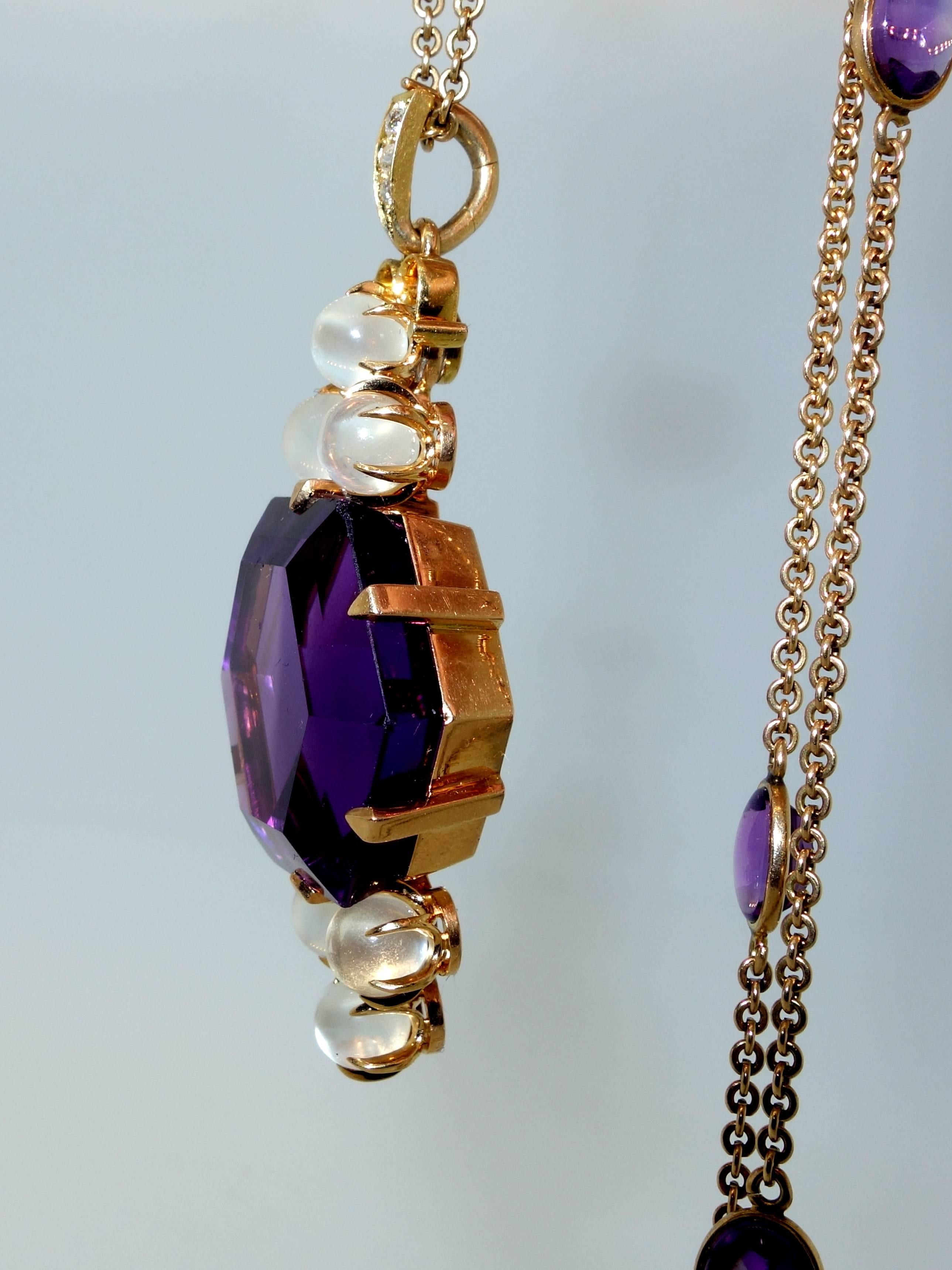 Classic Victorian necklace with approximately 20 ct. hexagonal fine amethyst (probably Siberian based on it's fine deep purple color), accented with moonstones.  The chain is interspersed with 6 amethysts.  The necklace is 14K gold and a total of 23