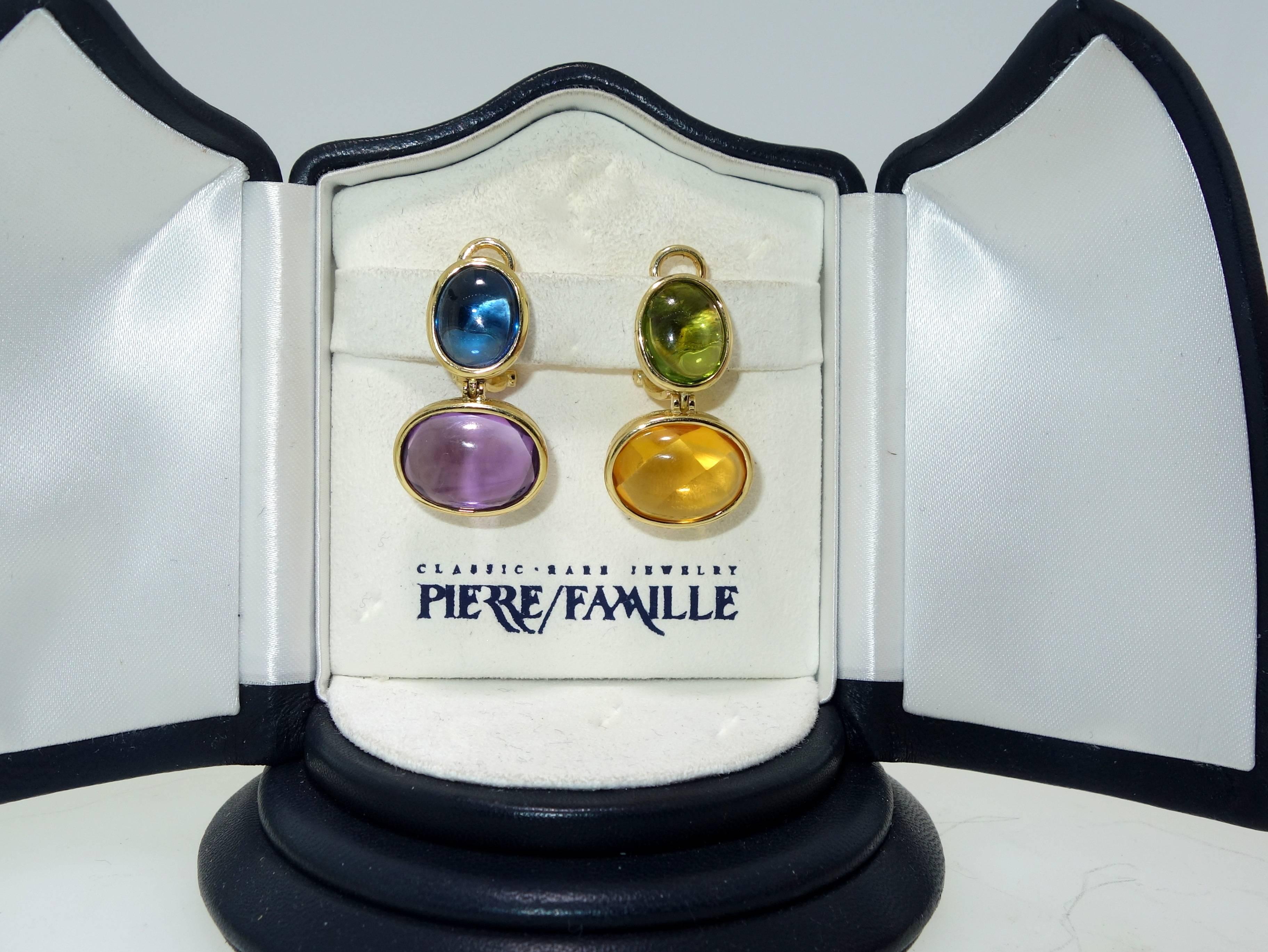 18K yellow gold possessing four different bezel set cabachon cut stones: Amethyst, citrine, peridot and blue topaz.  These colorful  earrings are 1.25 inches long. 17 grams in weight.  These earrings can be worn either pierced or non pierced and we