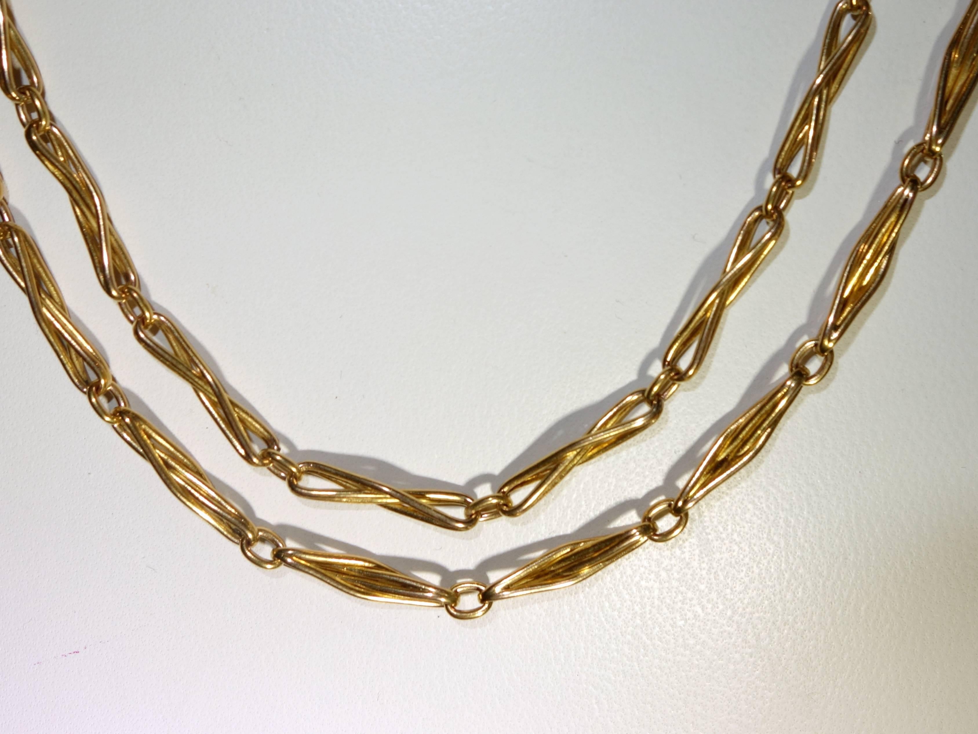 62 inches long, this 18K necklace is as supple with a distinctive link. 60 .45 grams.  It is long enough to wear tripled around the neckline.