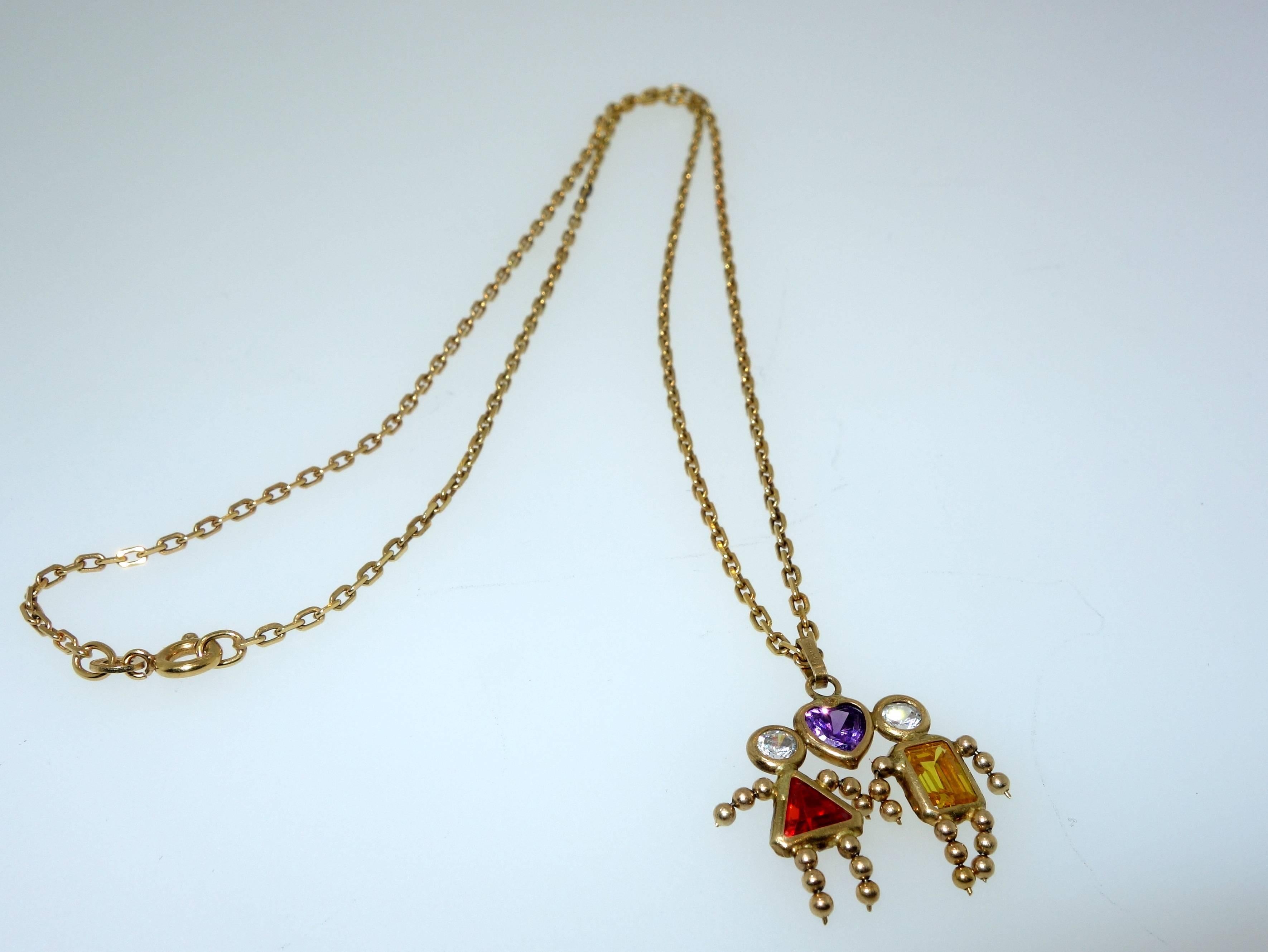 Charming charm necklace in 14K gold, the gold charm hanging from the 14K chain, which is 20 inches long and with the 1 inch charm creates a 21 inch long pendant necklace.  The charm's stones are synthetic which makes this romantic and colorful piece
