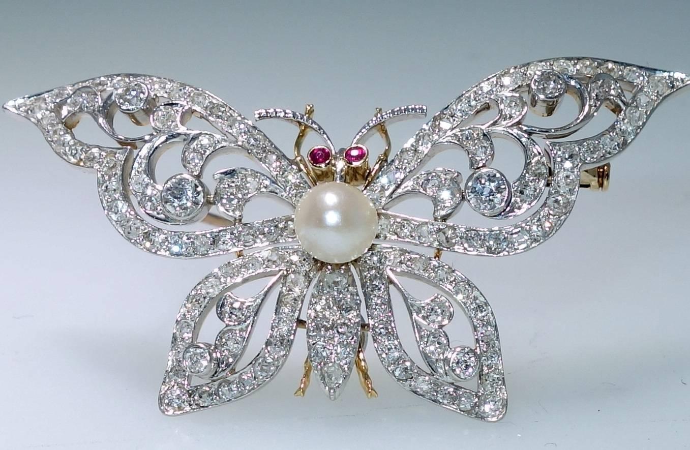 Belle Epoque diamonds, natural pearl and small rubies.  This brooch is a beautiful example of early 20th century workmanship.  2.6 cts of European cut diamonds are set in platinum and backed with 18K gold centering a 6 mm natural pearl.  This piece