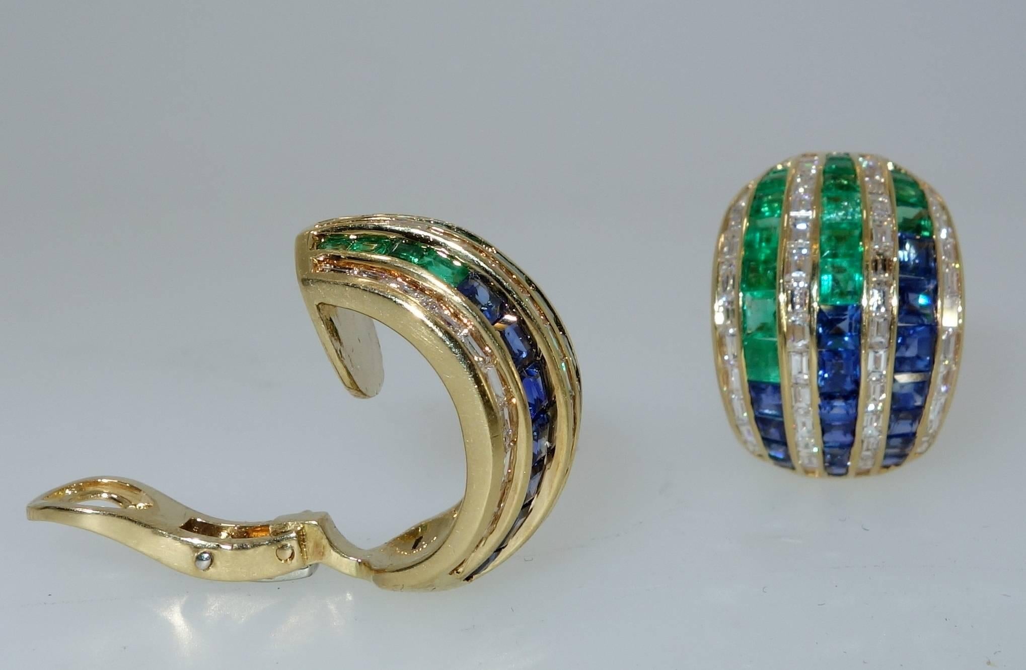Five carats of diamonds, two carats of emeralds and 2.7 carats of sapphires in 18K.  The Earrings are an unusual design by the famous London designer, David Morris.