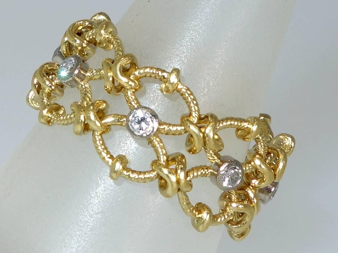 18K yellow gold set with  round white diamonds weighing approximately .45 cts., this flexible chain link ring is a size 8 and we can size easily to fit the new wearer.  Unusual in design and easy to wear!