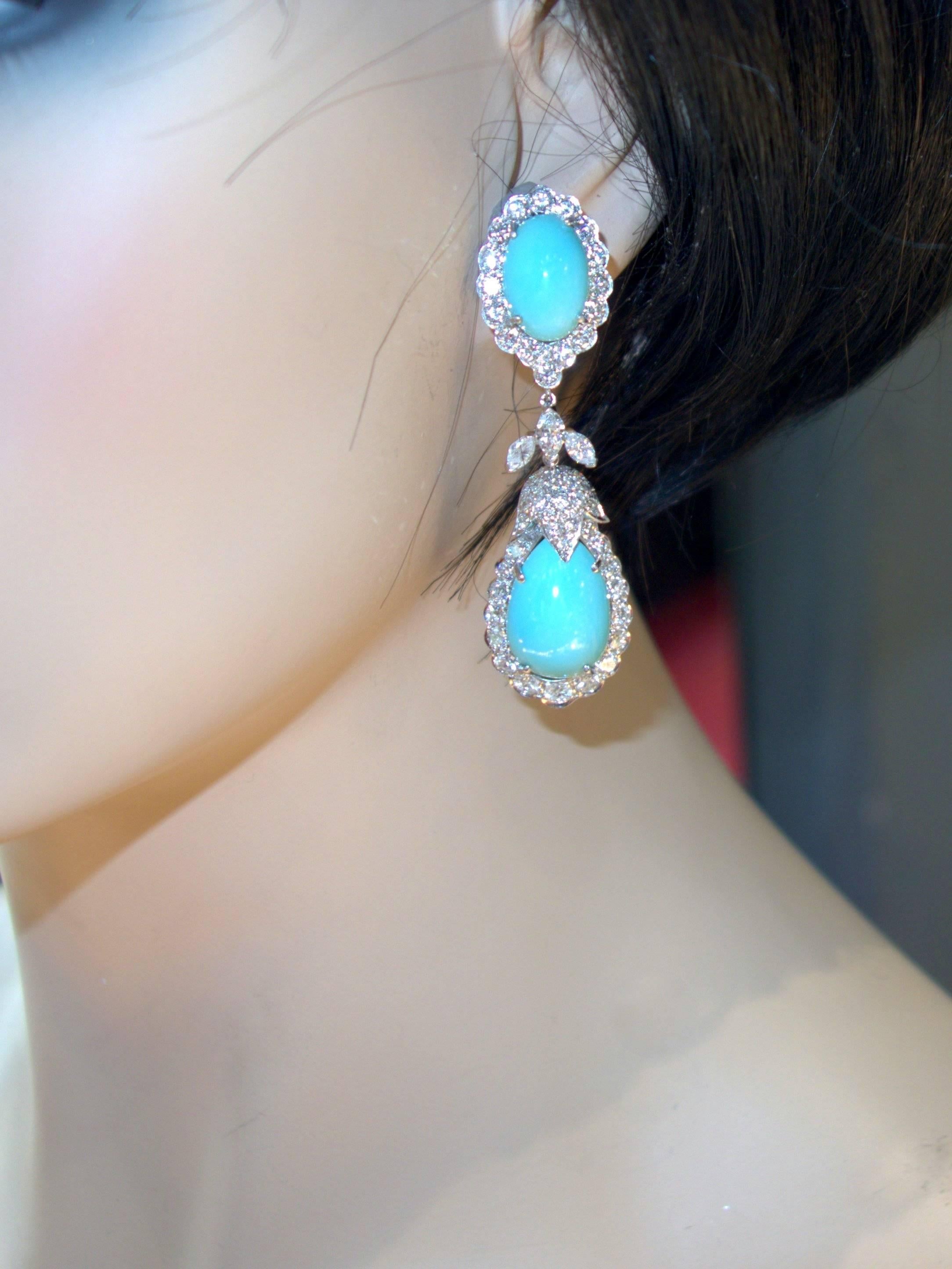 About 2.75 inches long with 108 fine white diamonds, both round and marquise cut, weighing approximately 7.3 cts., and centering bright robin's egg blue natural turquoise, these earrings are a bright statement for the ear.  Circa1960