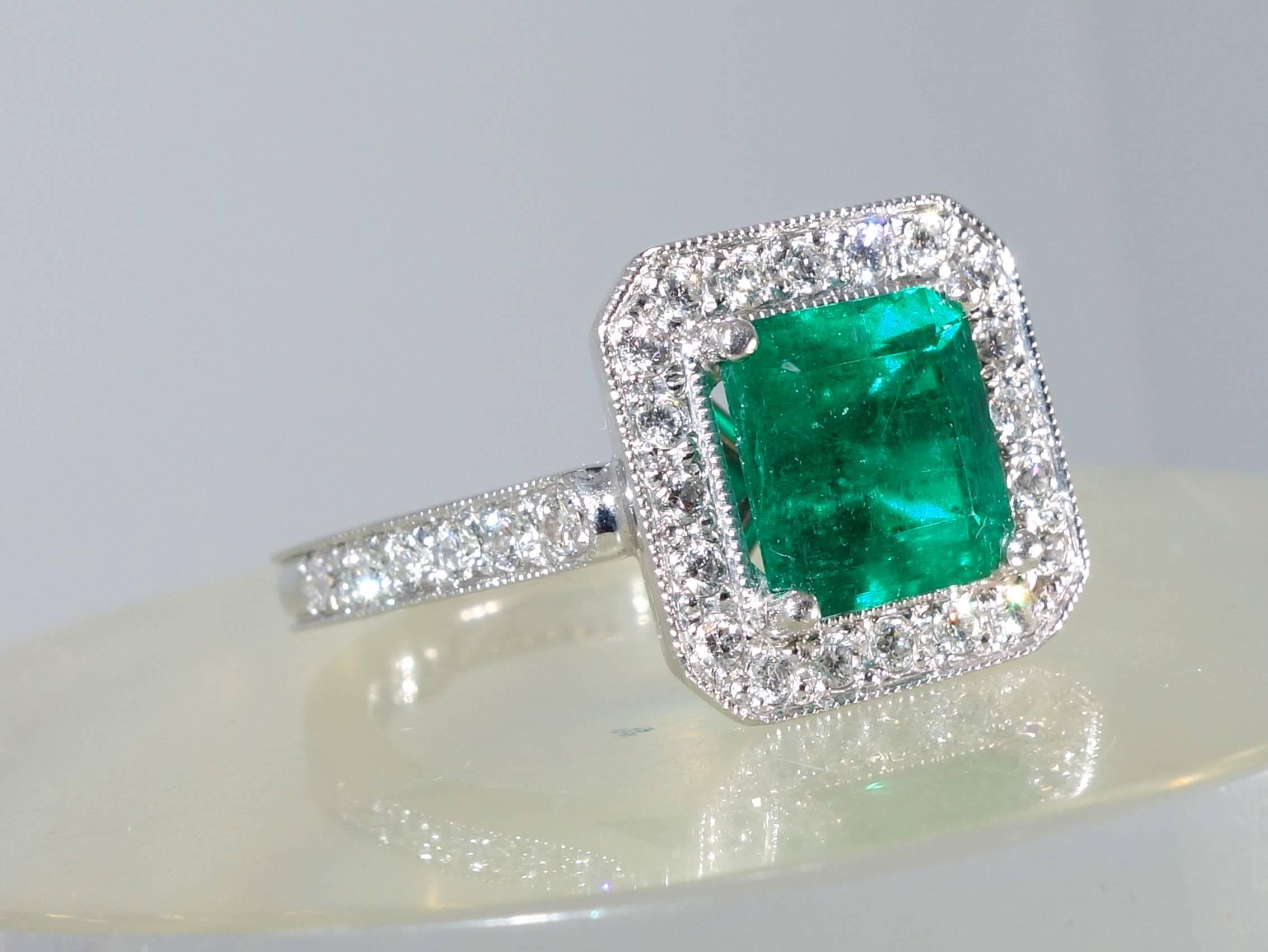 32 fine white diamonds (H/VVS) are bead set around a fine natural emerald.  These diamonds weigh approximately .54 cts.  The center emerald which displays a bright green color weighs approximately 1.91 cts.  This platinum ring is a size 6 and can