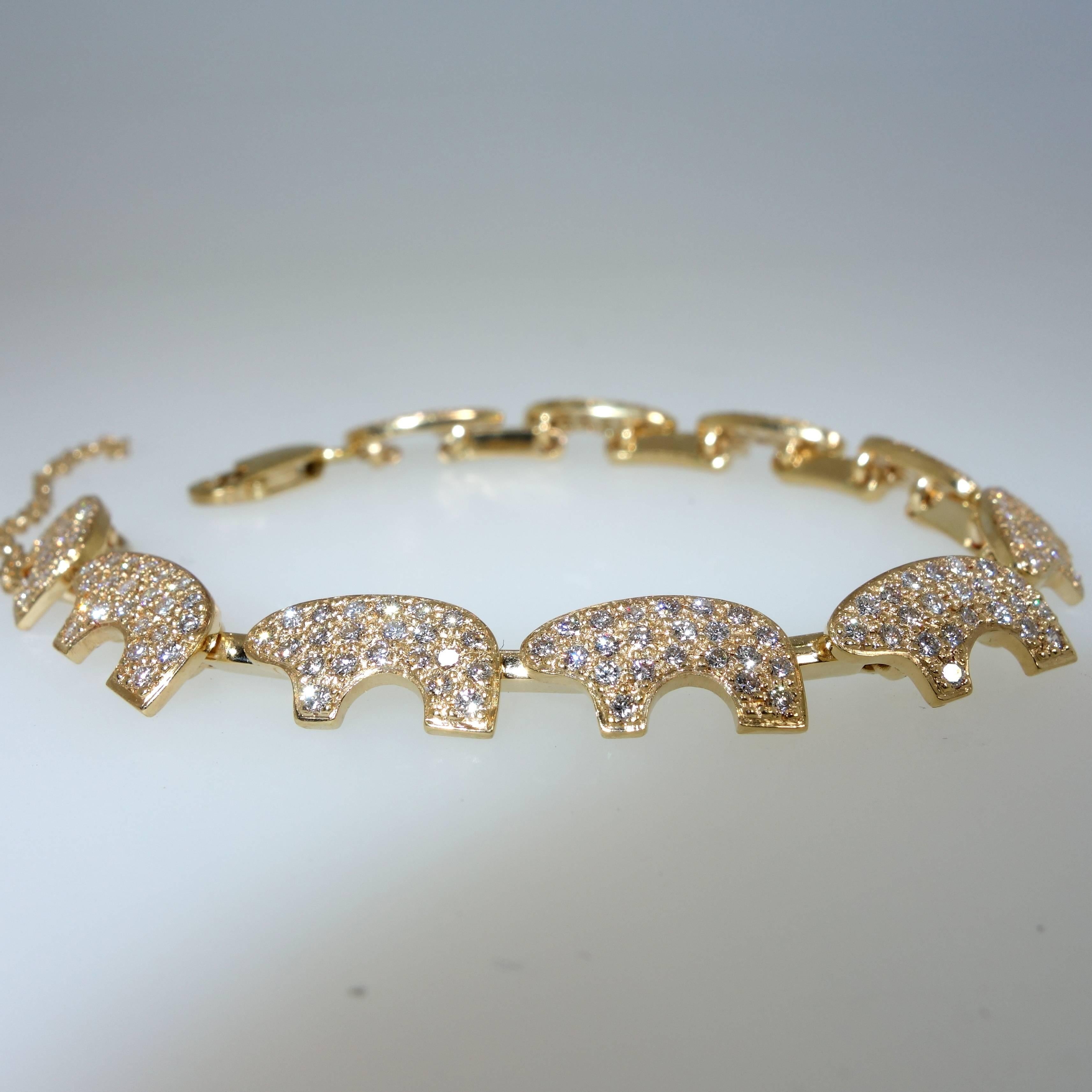 Ten finely pave set diamond bears hand crafted in yellow gold.  There are 220 well matched and finely cut white (H) and very slightly included (VS) diamonds weighing approximately 3.3 cts.  The bracelet is is a hair shorter than seven inches weighs