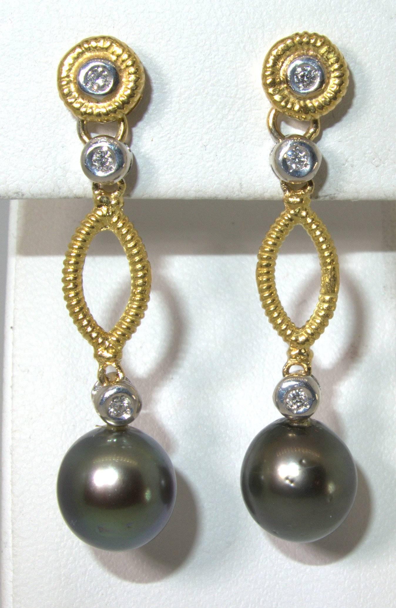 18K yellow gold suspending 10 mm. matching black pearls which are accented with wound modern brilliant cut diamonds which all set in 18K white gold.  These earrings weigh 7.5 grams, are just over 1.5 inches long.