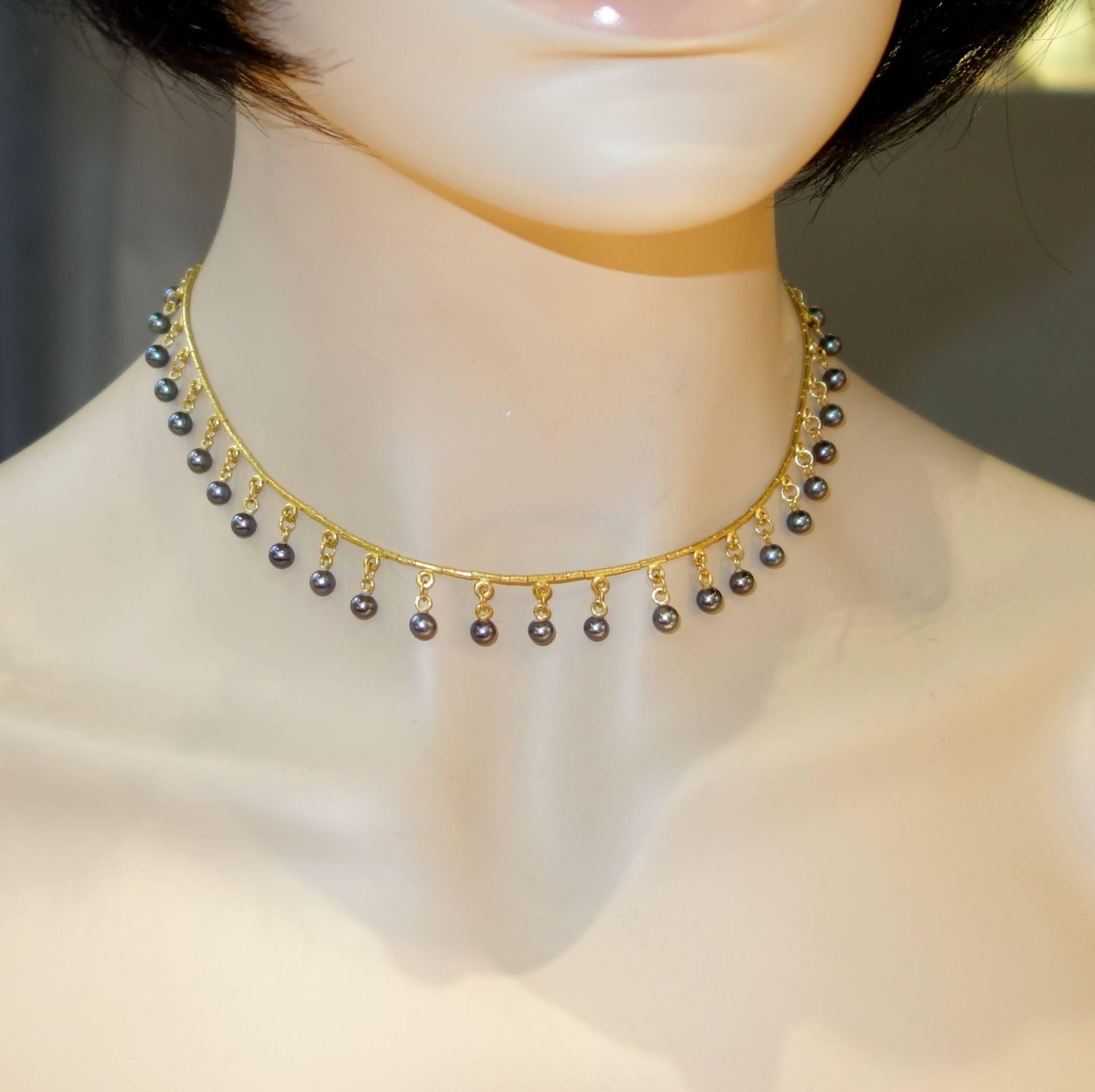 4.6 mm black pearls are suspended from a hand made 23K gold intricate chain.  Made by the Greek firm Gurhan.   15.5/8 inches long - to be worn right at the collar.  The matching black pearls are all well matched displaying a fine luster creating a