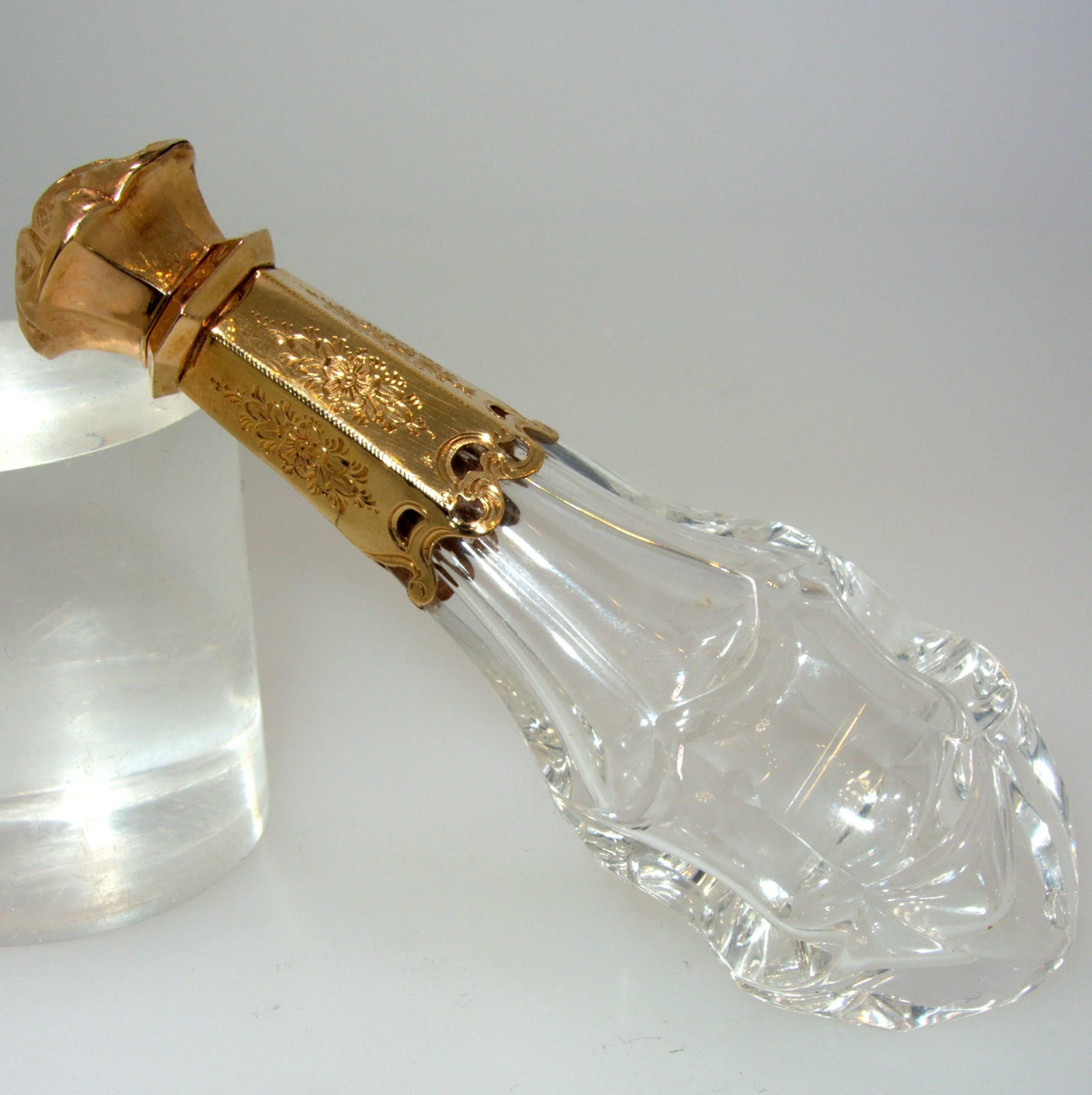 With beautiful engraving, this 18K yellow gold perfume bottle is nearly five inches high.