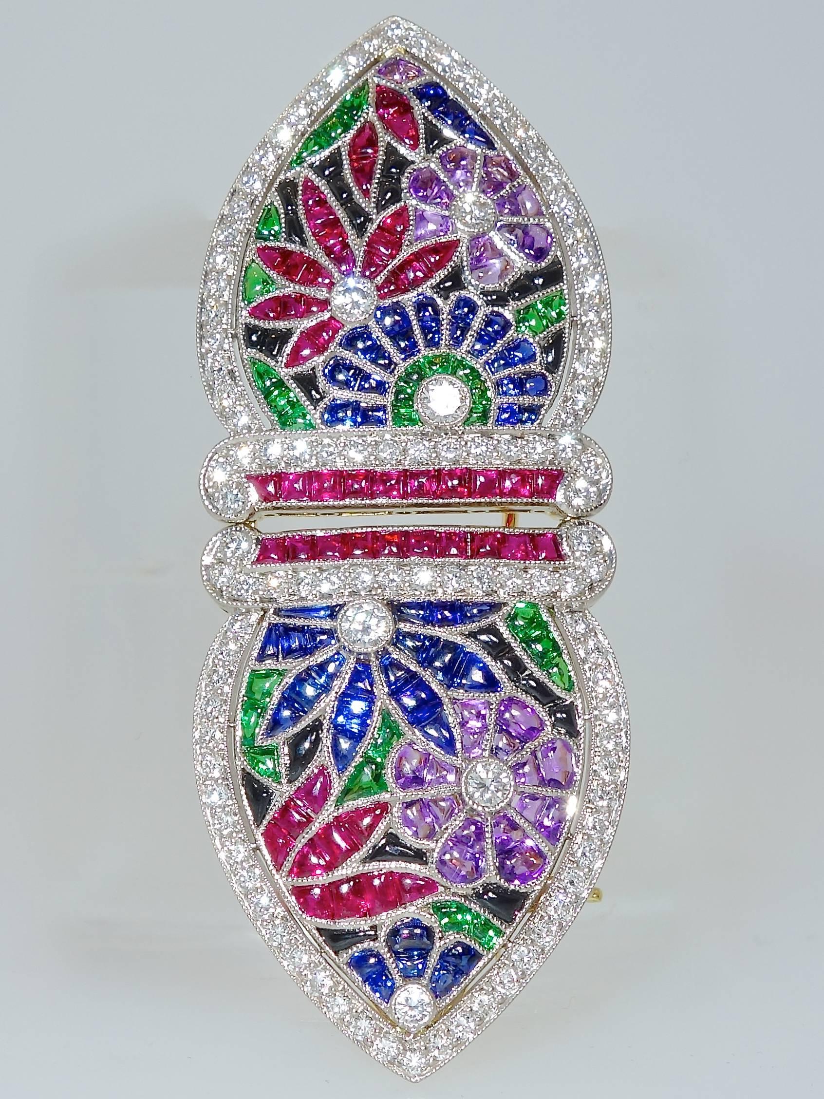 Buff topped, faceted bottom, fine bright gem stones: rubies, sapphires, emeralds, onyxes, amethysts and white brilliant cut diamonds. 2.75 inches long.  Millgrained bezels in 18K white and yellow gold finish the description of the mechanics of this